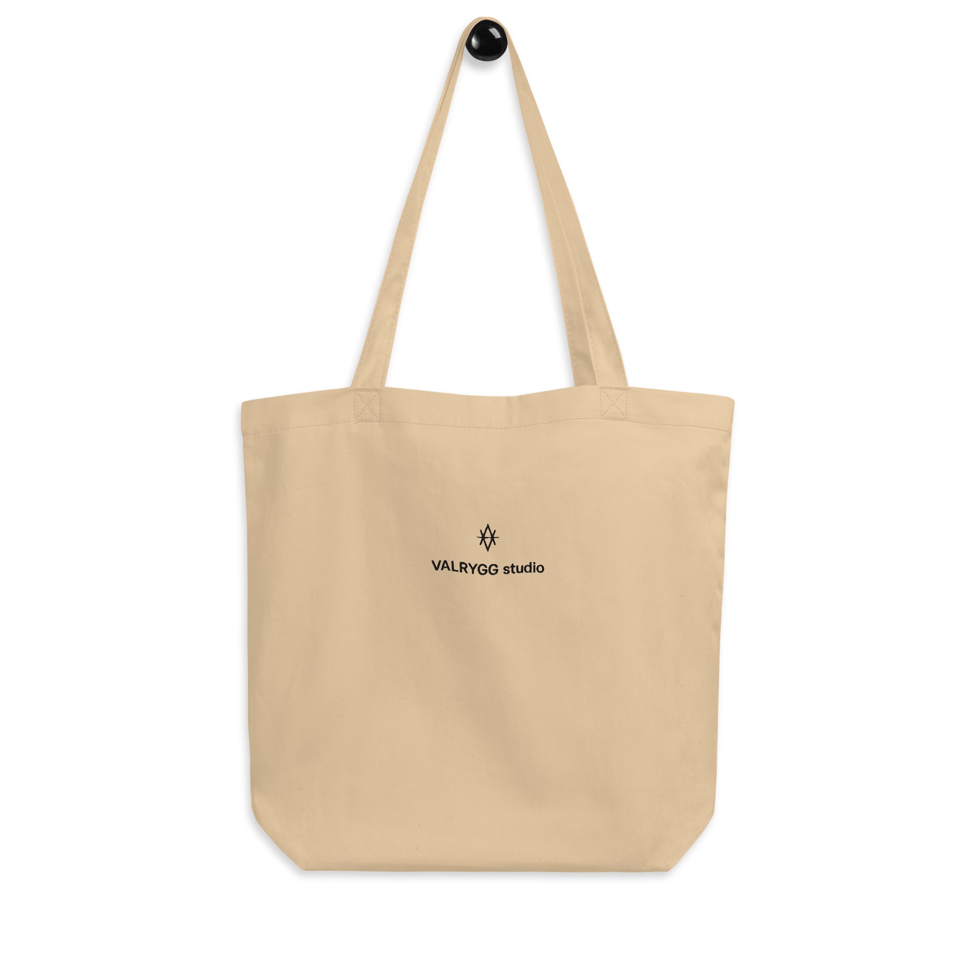 Organic cotton tote bag with dual straps, spacious design, perfect for groceries and books.