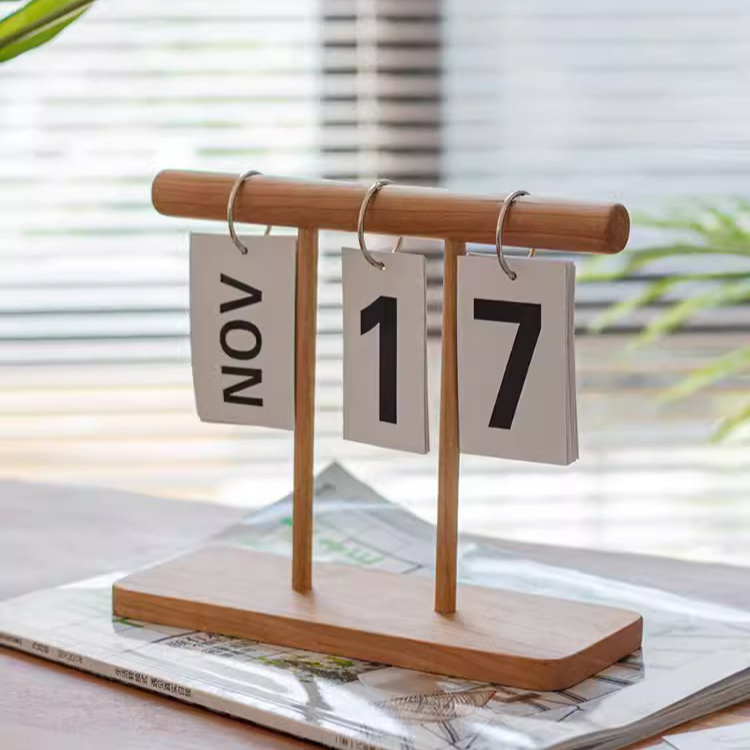 A handcrafted Page-Flipping Wooden Desktop Calendar made from rubber wood, cherry wood, and ash wood, showcasing its unique design and natural colors.