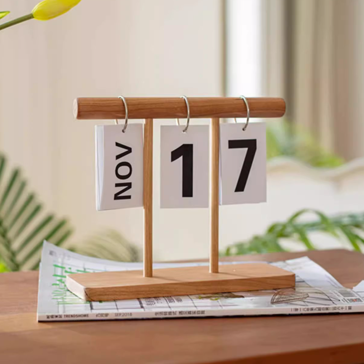 A handcrafted Page-Flipping Wooden Desktop Calendar made from rubber wood, cherry wood, and ash wood, showcasing its unique design and natural colors.