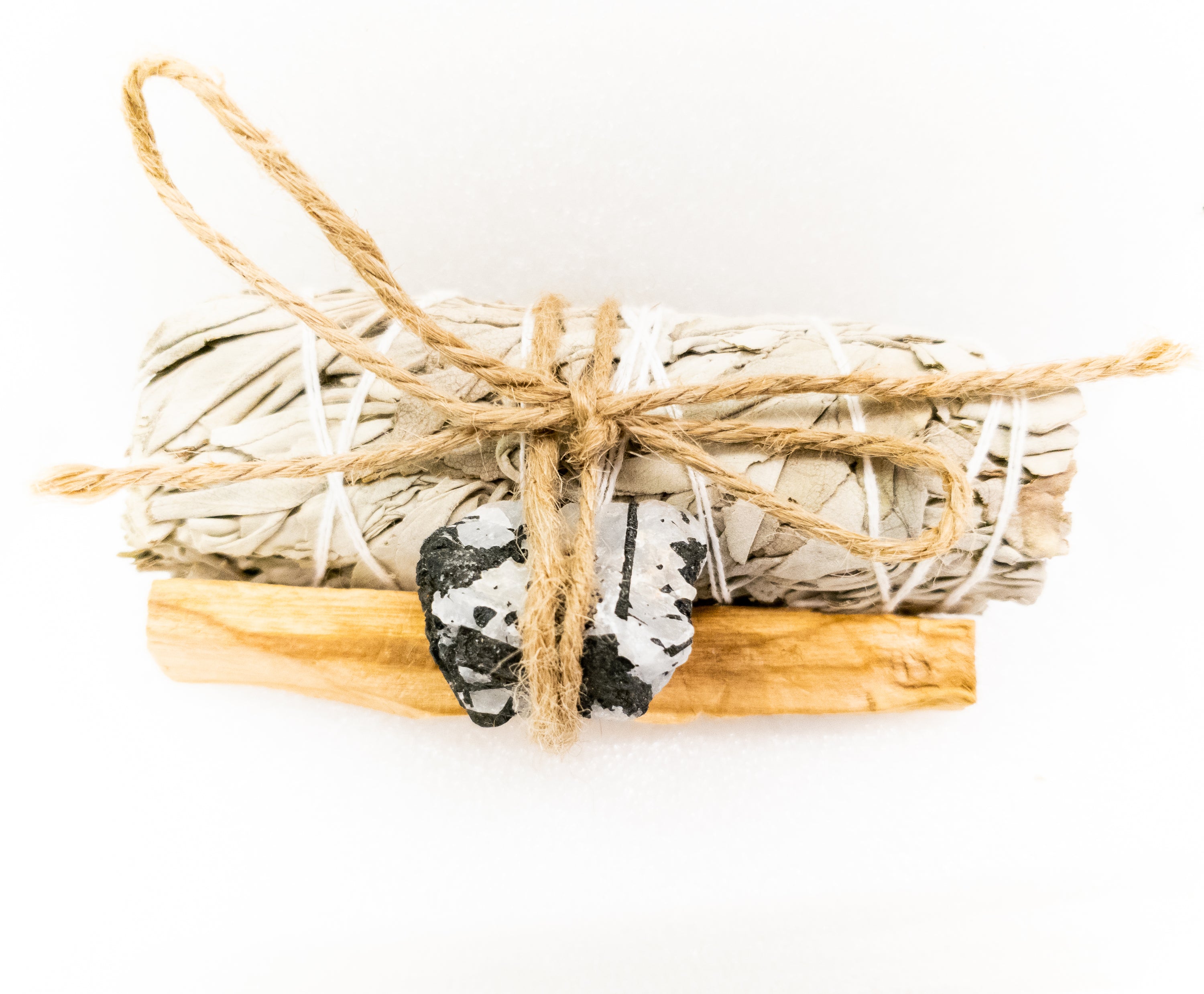 Palo Santo and Sage smudging bundle with assorted crystals, showcasing natural wood and vibrant crystal colors.