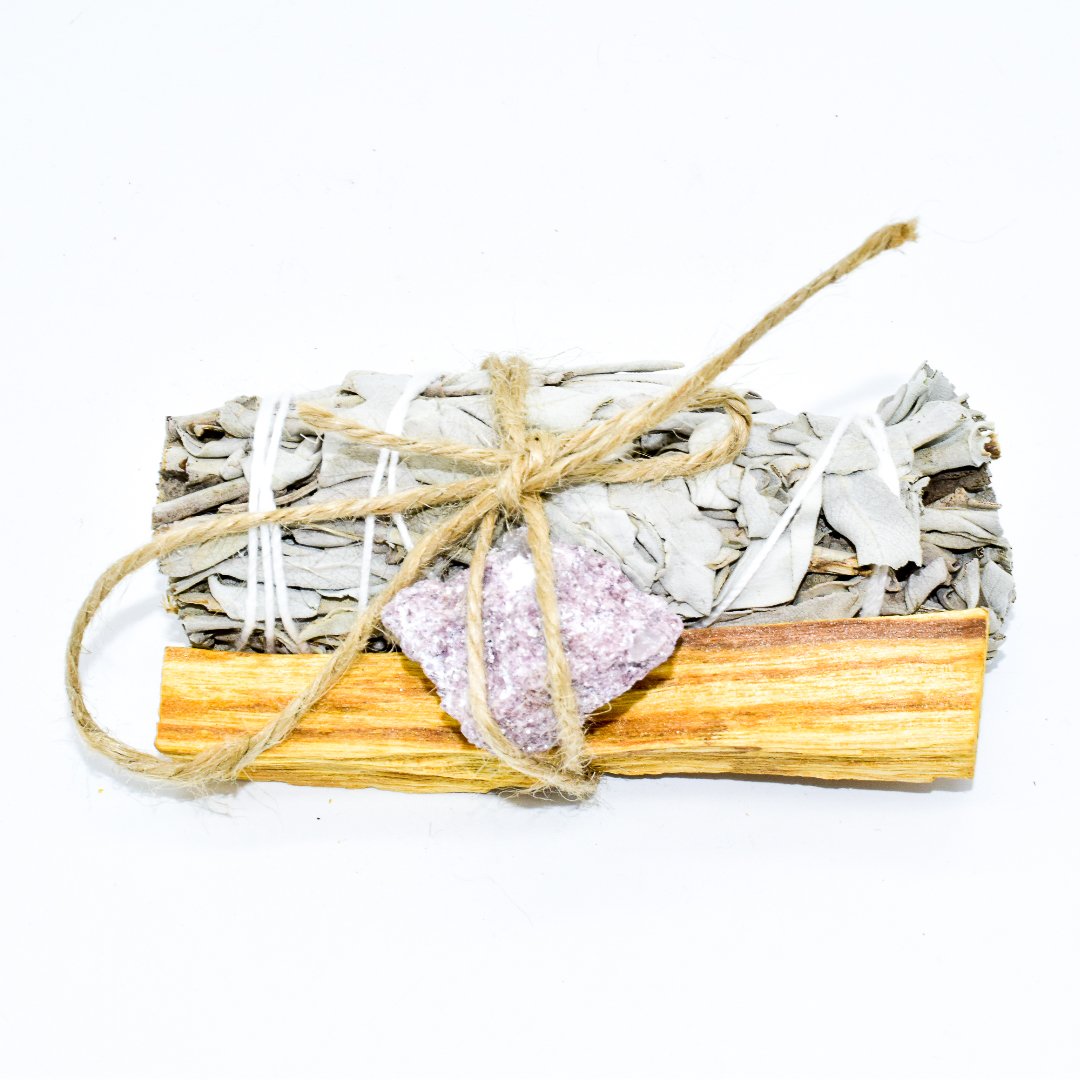 Palo Santo and Sage smudging bundle with assorted crystals, showcasing natural wood and vibrant crystal colors.