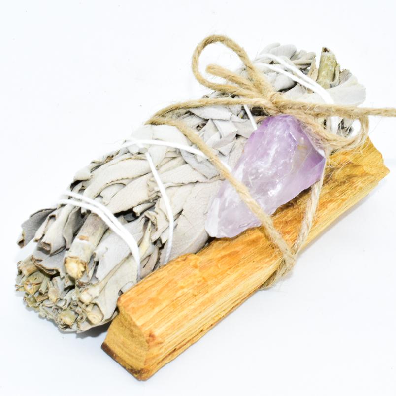 Palo Santo and Sage smudging bundle with assorted crystals, showcasing natural wood and vibrant crystal colors.