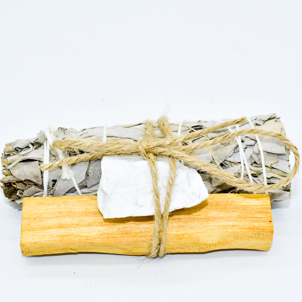 Palo Santo and Sage smudging bundle with assorted crystals, showcasing natural wood and vibrant crystal colors.