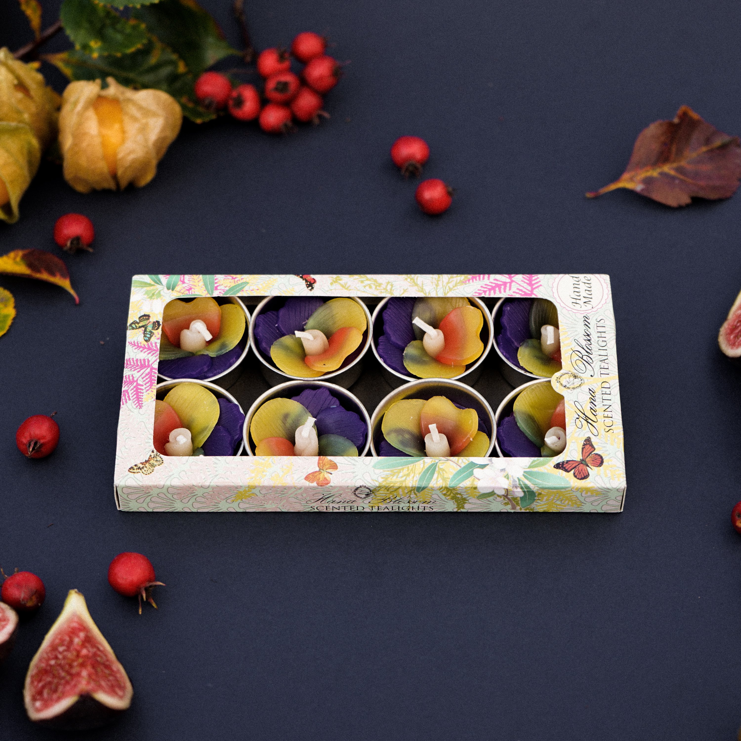 A set of handmade Pansy Scented Tealights in purple and yellow, beautifully packaged in a botanic garden printed box.