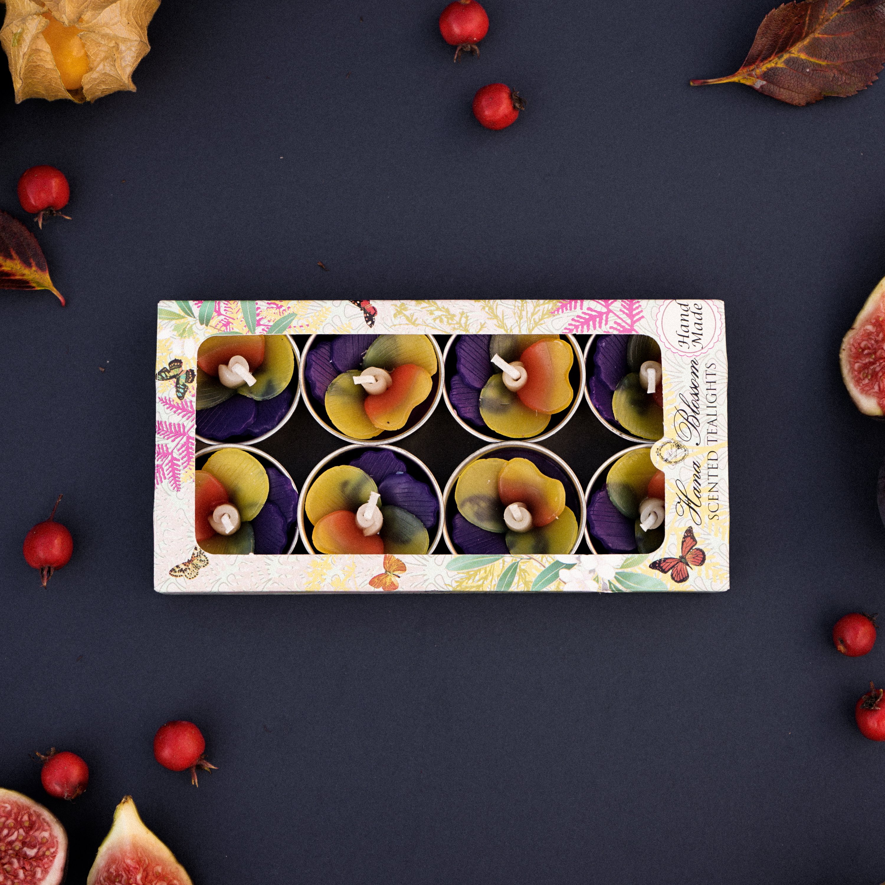 A set of handmade Pansy Scented Tealights in purple and yellow, beautifully packaged in a botanic garden printed box.