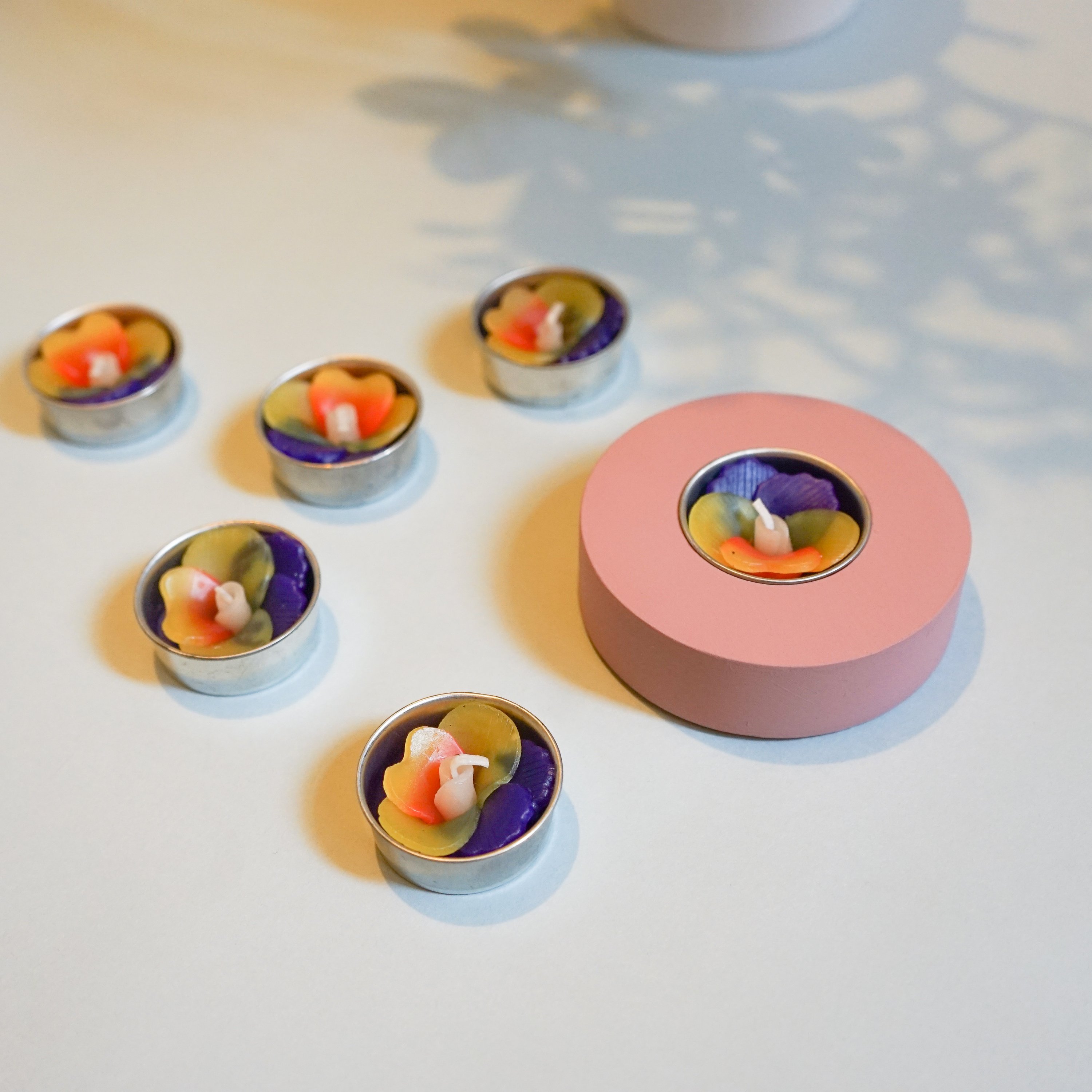 A set of handmade Pansy Scented Tealights in purple and yellow, beautifully packaged in a botanic garden printed box.