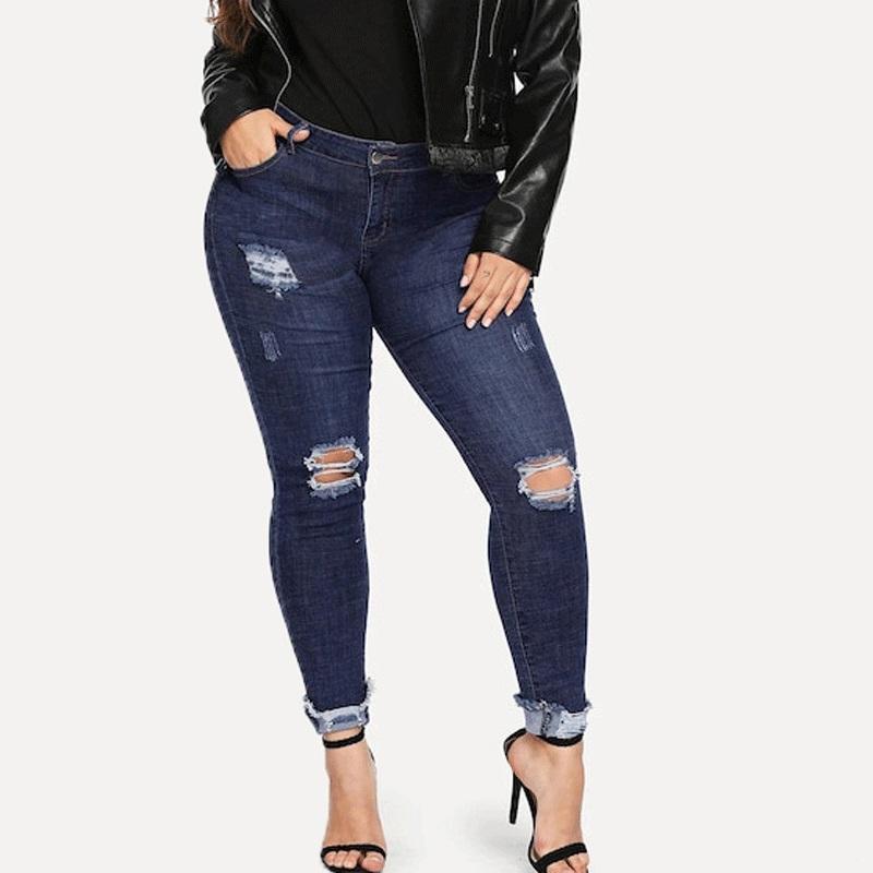 A pair of dark blue plus sized slim-leg jeans for women, showcasing a stylish pencil pant design.