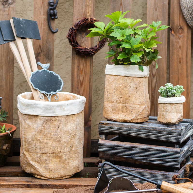 Paper Bag Style Concrete Garden Pot in khaki color, showcasing its unique design and drainage hole.