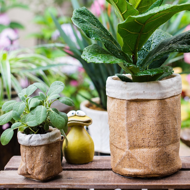 Paper Bag Style Concrete Garden Pot in khaki color, showcasing its unique design and drainage hole.