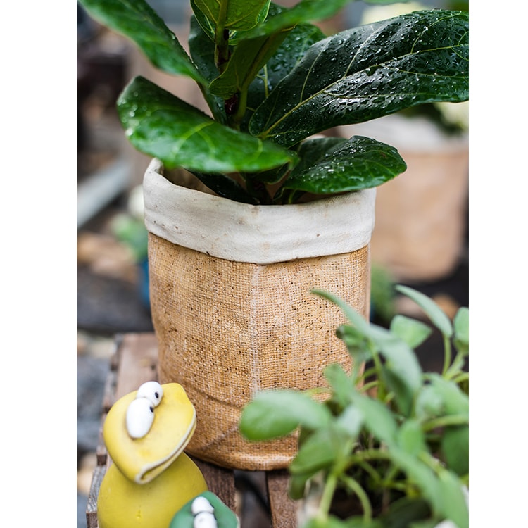 Paper Bag Style Concrete Garden Pot in khaki color, showcasing its unique design and drainage hole.