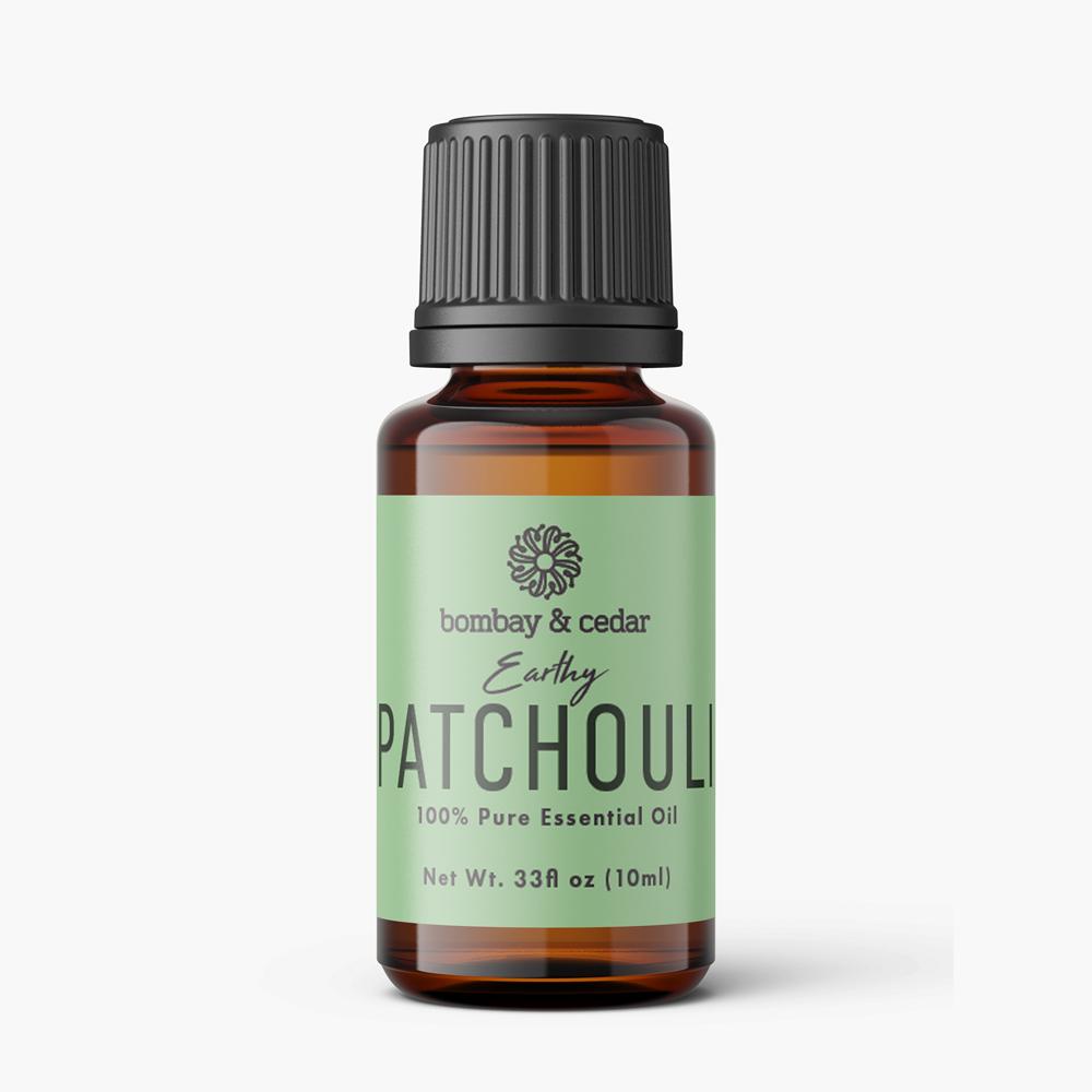 10ml bottle of Patchouli Essential Oil with a dark amber color, featuring a dropper lid and a label indicating its benefits and origin.