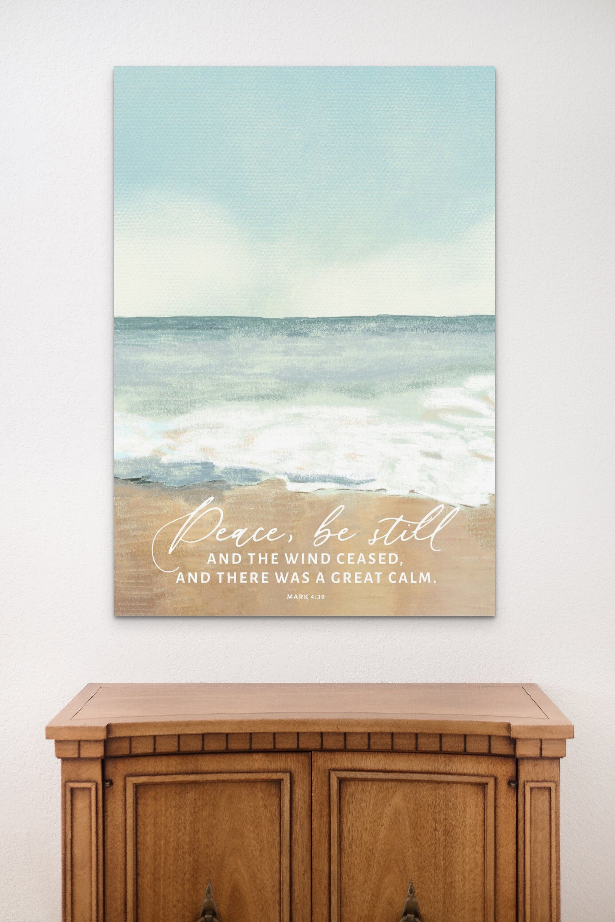 Peace be Still Coastal Canvas Wall Art featuring serene beach scene and inspirational Christian quote from Mark 4:39.