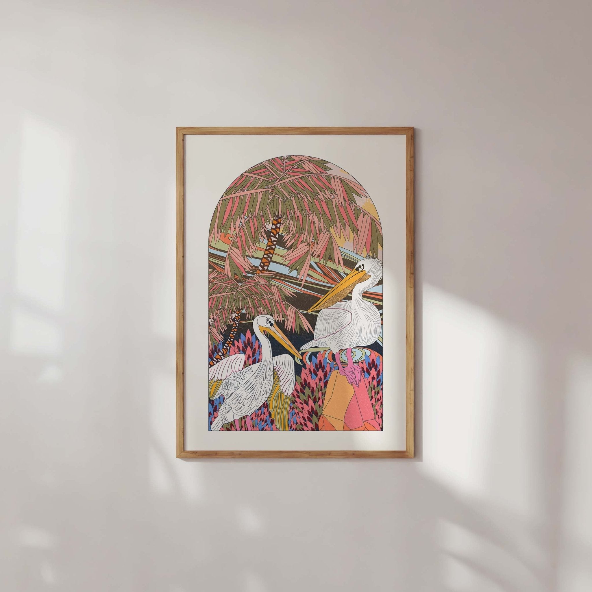 A vibrant Pelicans Art Print featuring two pelicans surrounded by palm trees and foliage, showcasing boho and vintage styles.