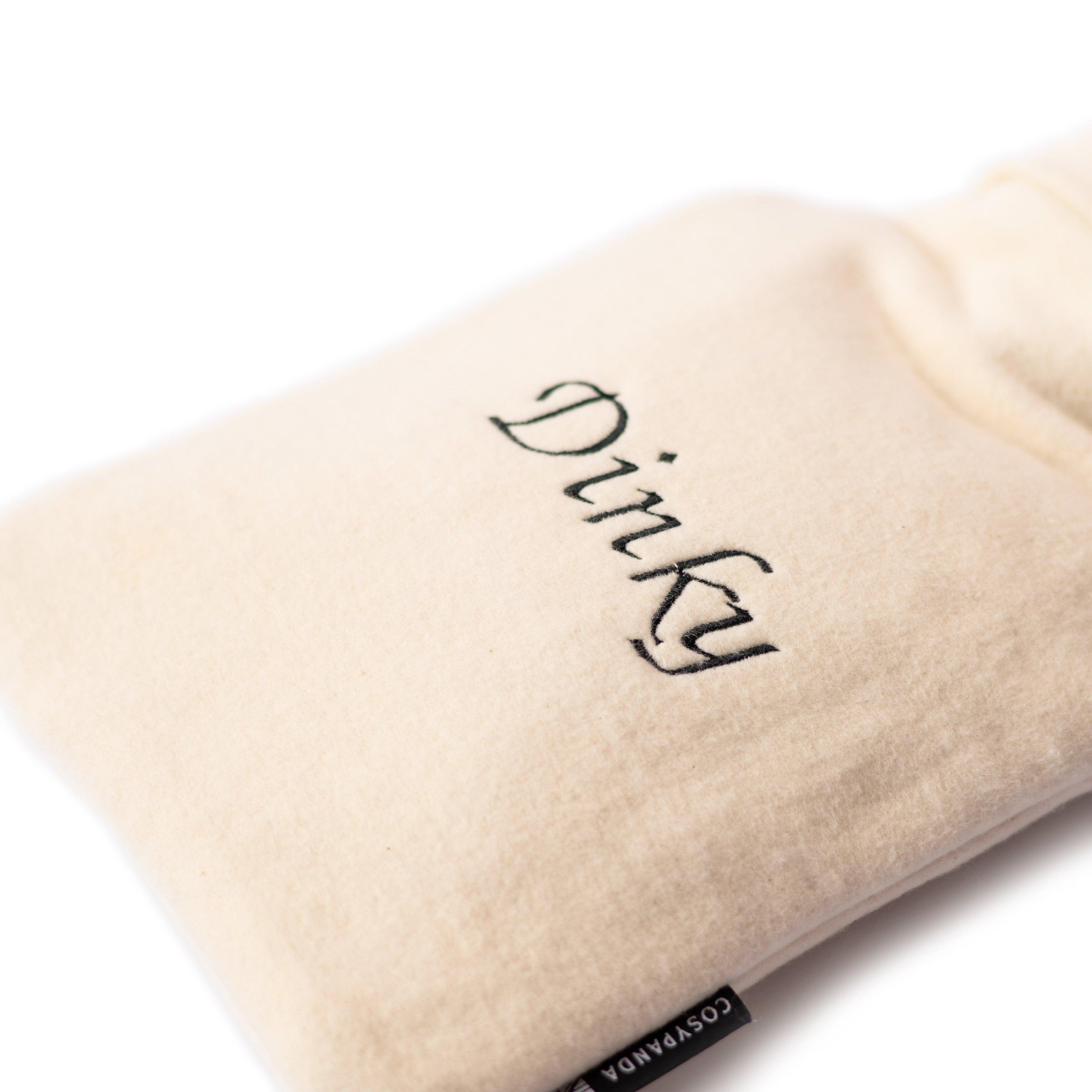 A cozy personalised hot water bottle cover made from bamboo and organic cotton, featuring embroidered names and initials, perfect for warmth and comfort.