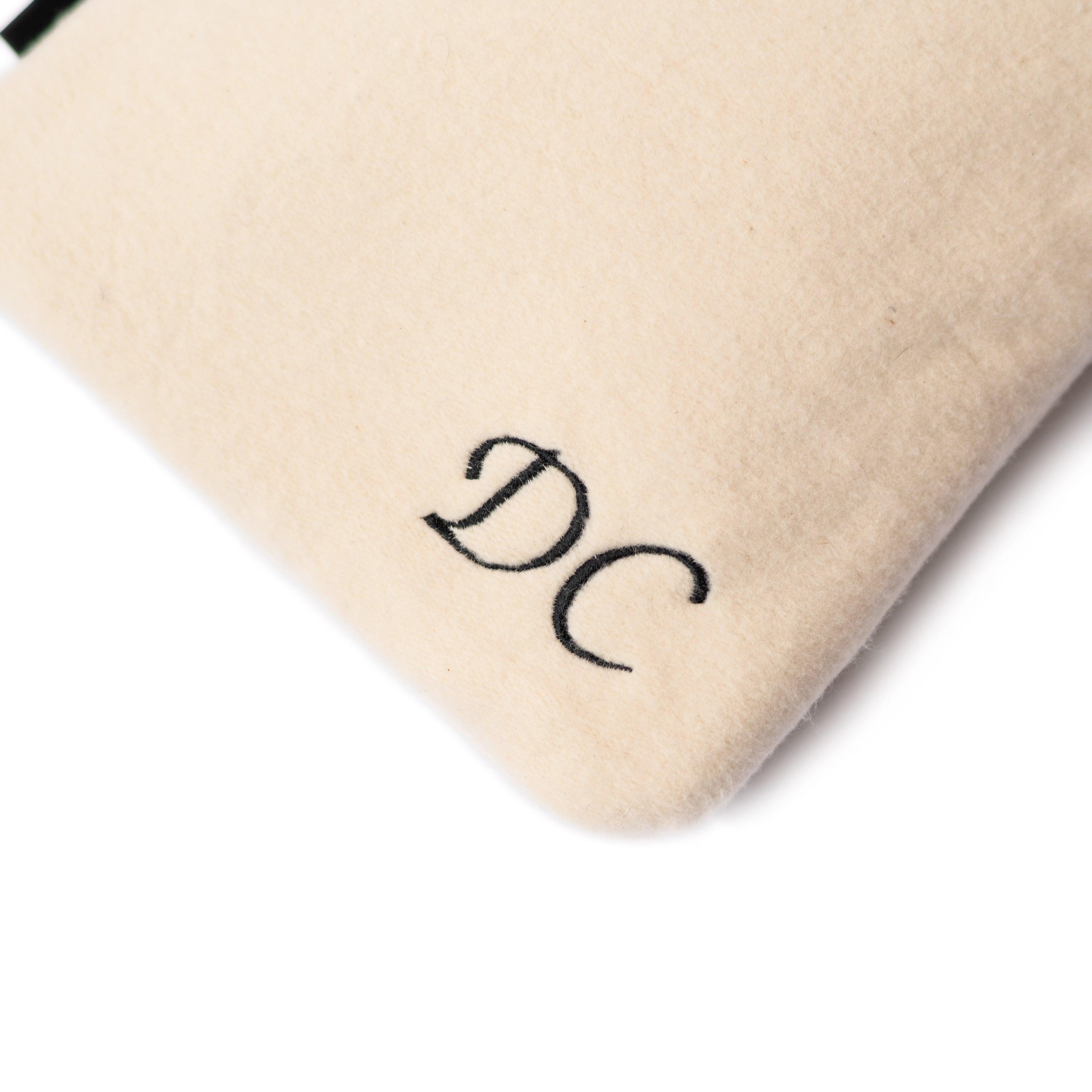 A cozy personalised hot water bottle cover made from bamboo and organic cotton, featuring embroidered names and initials, perfect for warmth and comfort.