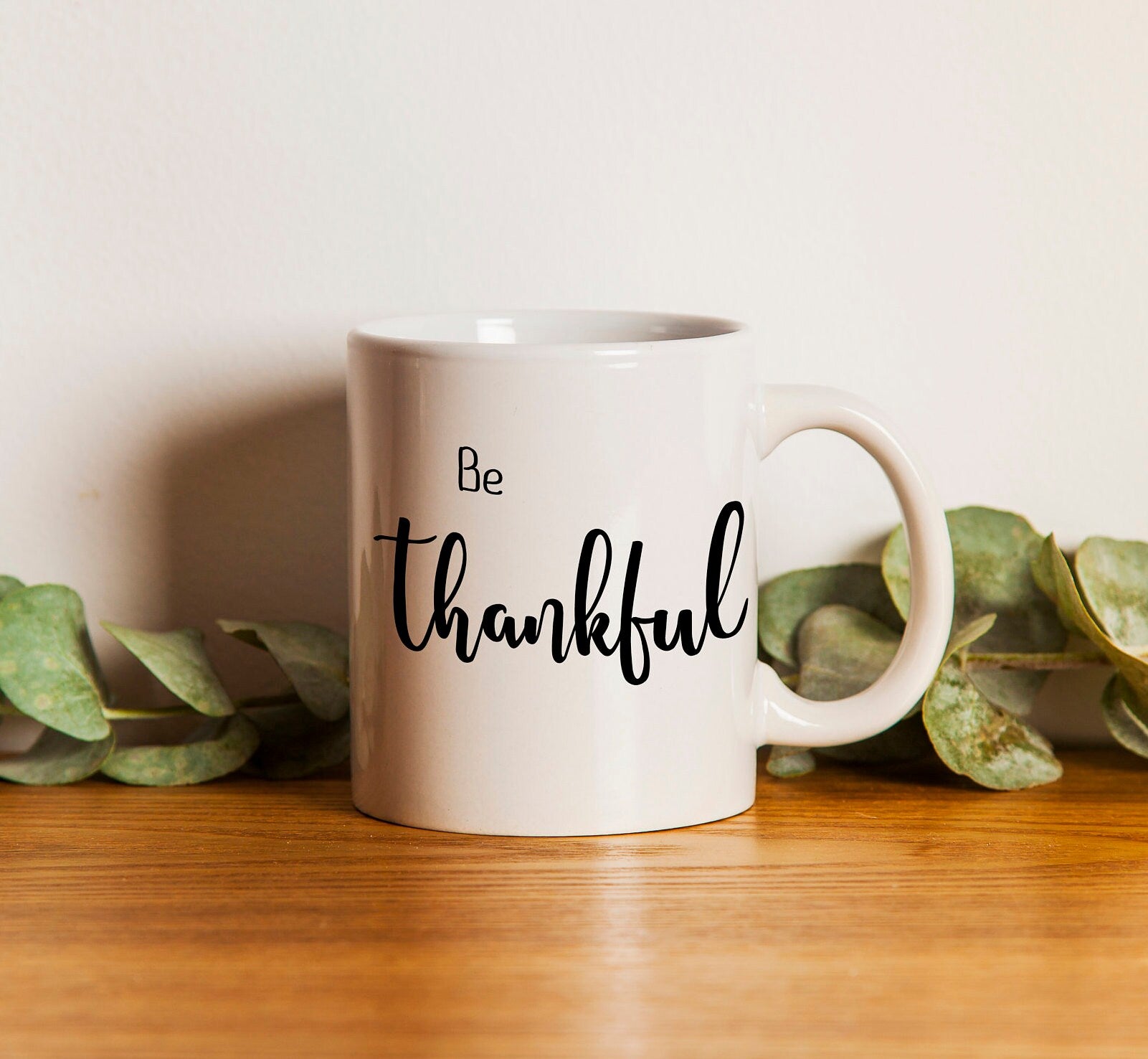 Personalized 'Be Thankful' coffee mug with hand lettered design, showcasing inspirational message on both sides.