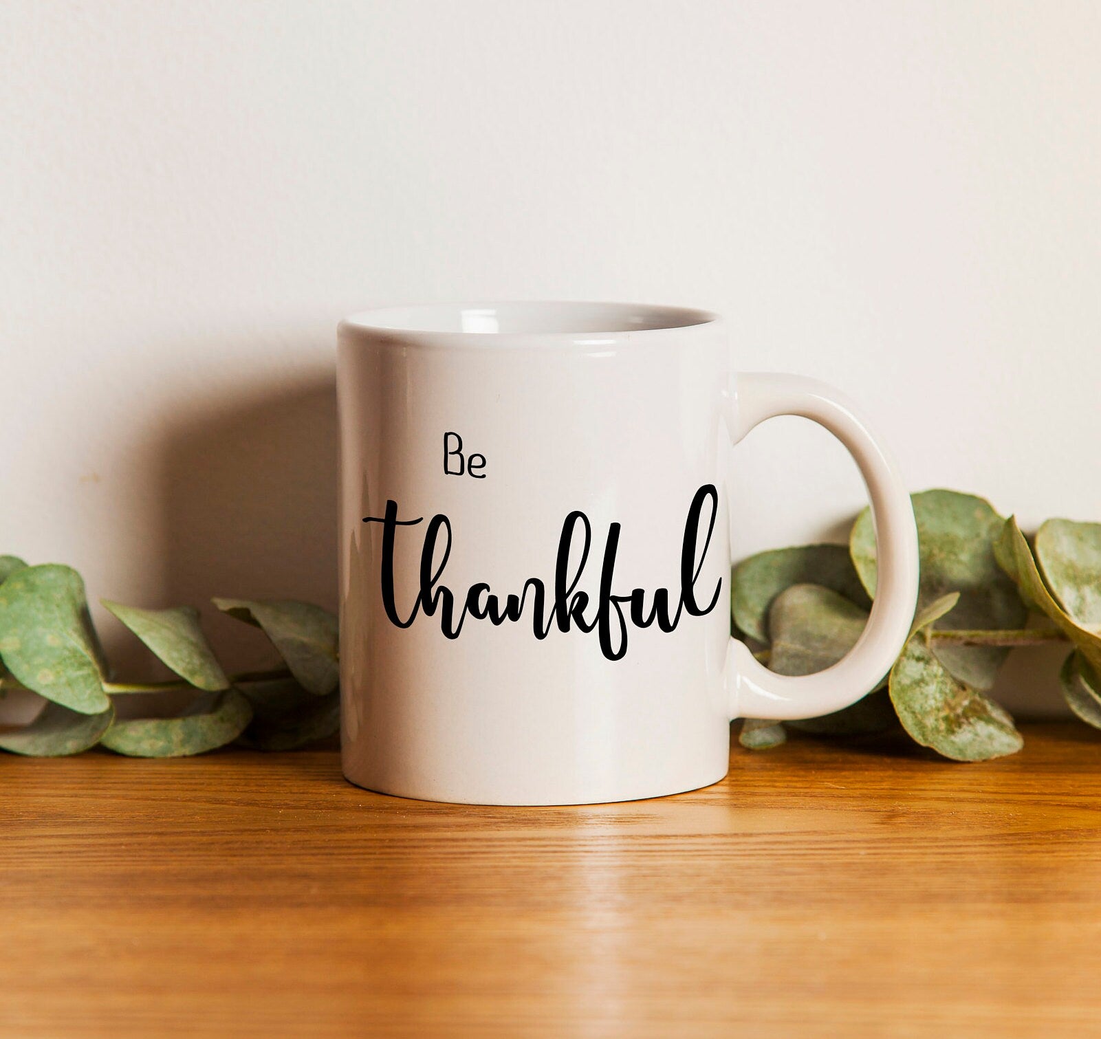 Personalized 'Be Thankful' coffee mug with hand lettered design, showcasing inspirational message on both sides.