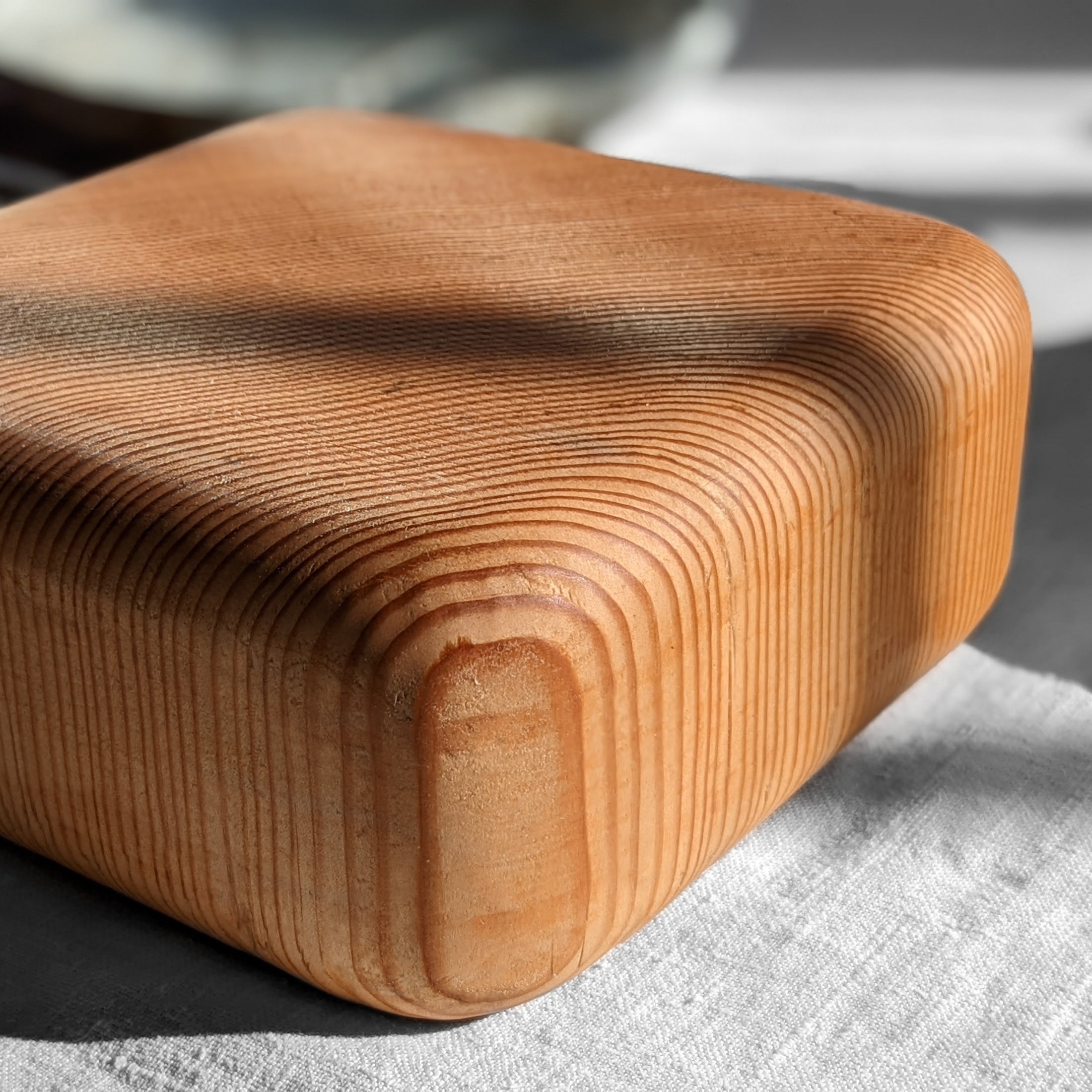 Elegant Pillow Trivet made from Doug Fir wood with soft edges, perfect for protecting surfaces while serving hot dishes.