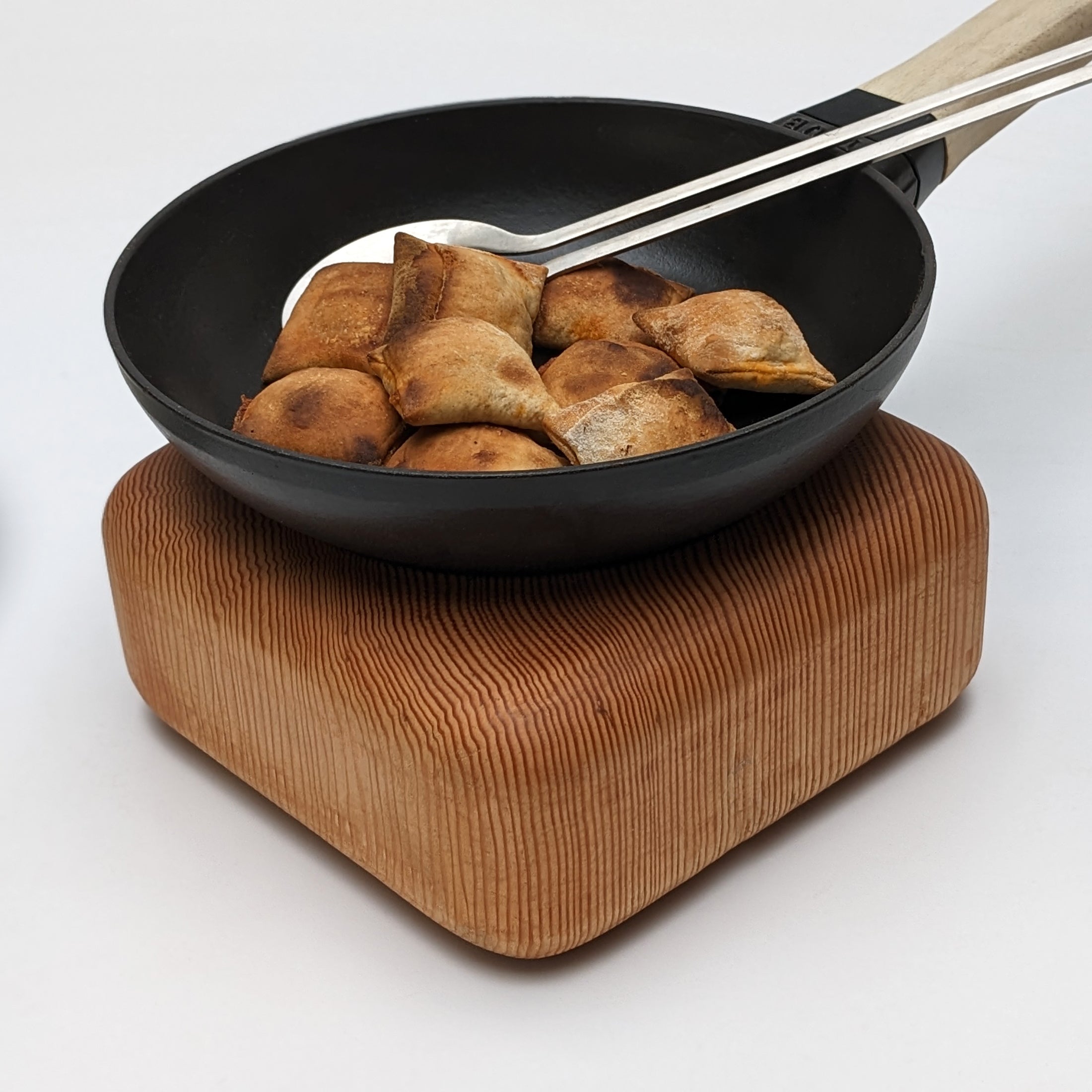 Elegant Pillow Trivet made from Doug Fir wood with soft edges, perfect for protecting surfaces while serving hot dishes.