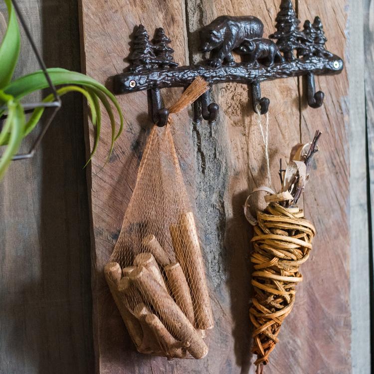 A collection of natural pine cones and wood pieces in various shapes and sizes, perfect for holiday decoration.