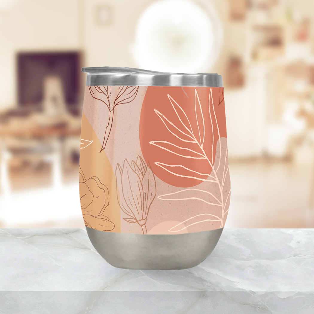 A stylish pink abstract desert wine tumbler made of stainless steel, featuring a double-wall design and a plastic lid, perfect for outdoor use.