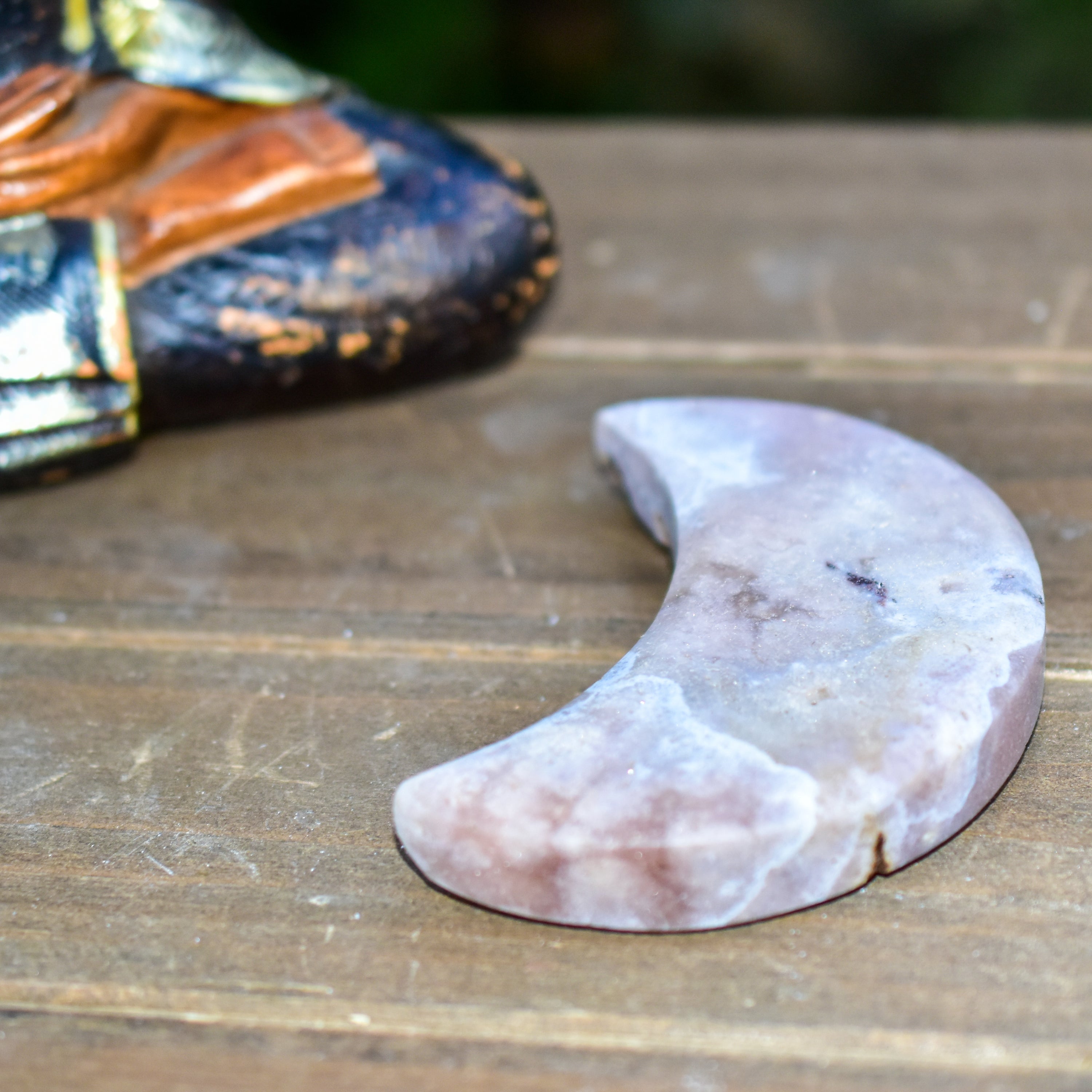 Handcrafted Pink Amethyst Crescent Moons showcasing unique colors and shapes, perfect for spiritual practices and home decor.