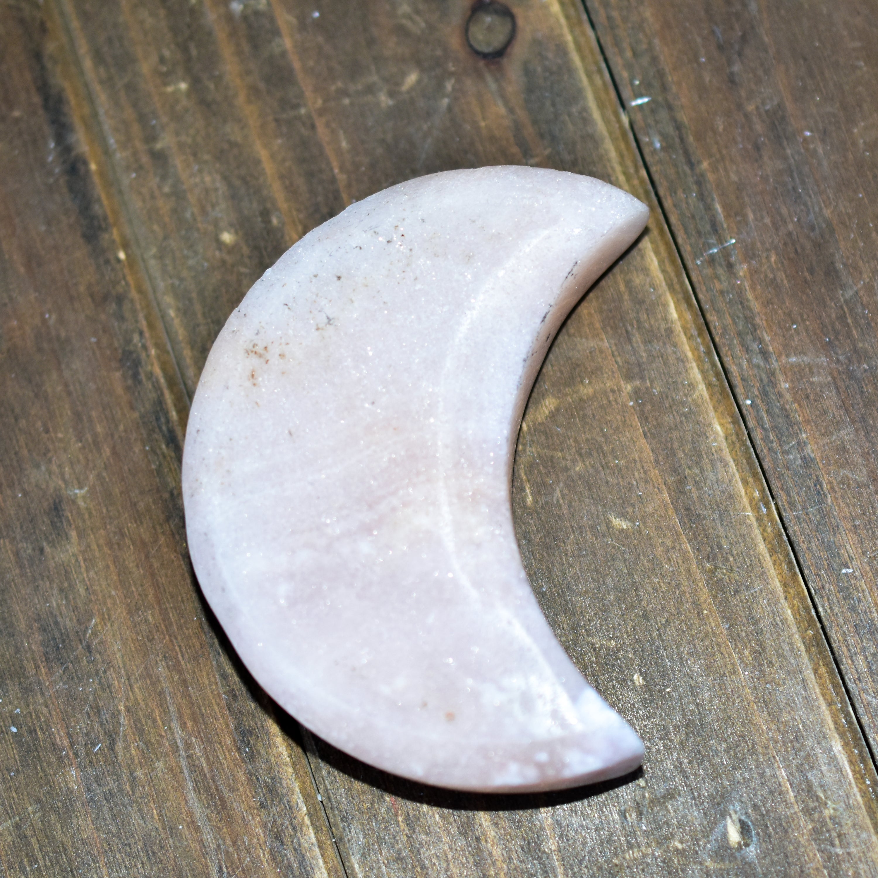 Handcrafted Pink Amethyst Crescent Moons showcasing unique colors and shapes, perfect for spiritual practices and home decor.