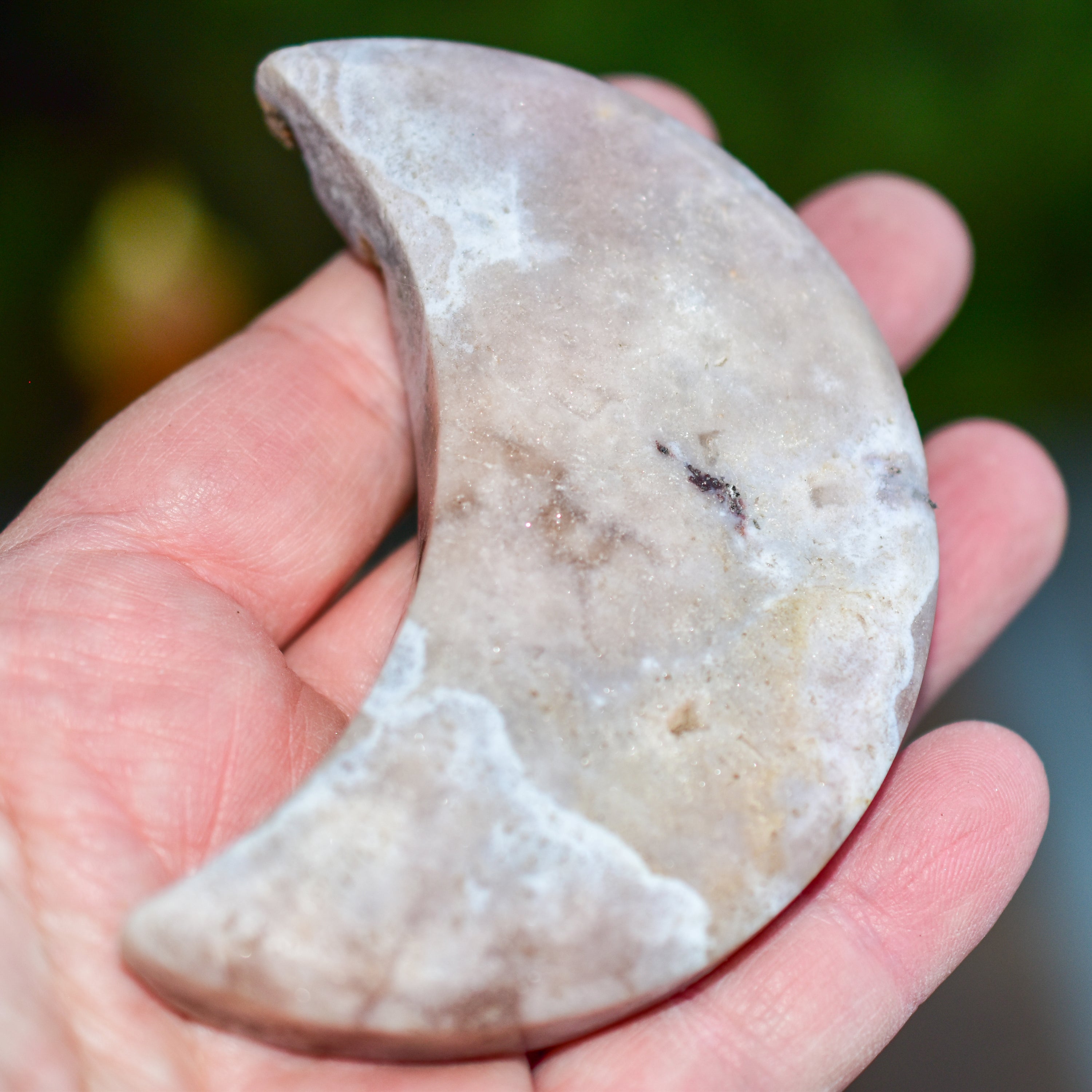 Handcrafted Pink Amethyst Crescent Moons showcasing unique colors and shapes, perfect for spiritual practices and home decor.