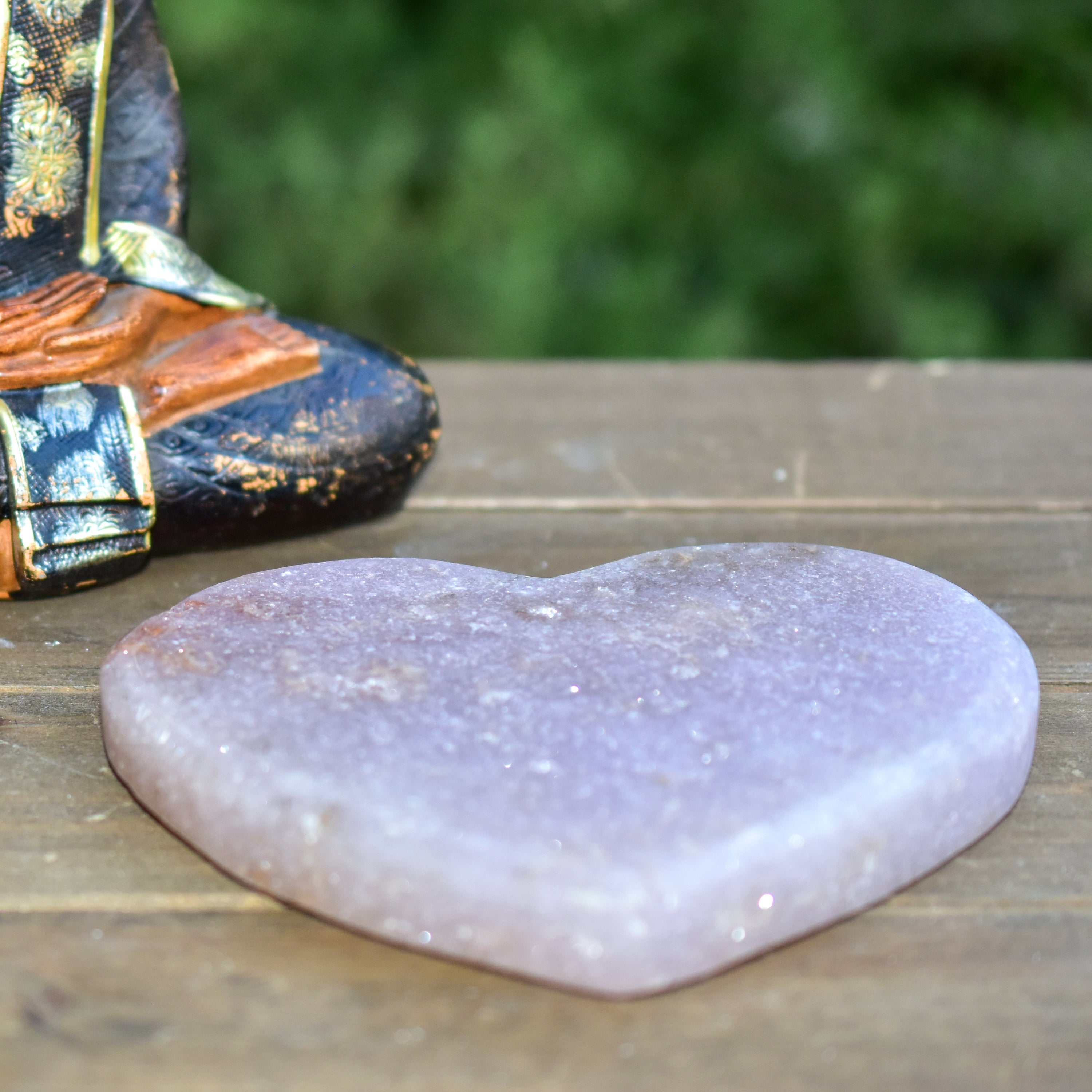 A collection of hand-cut Pink Amethyst hearts showcasing unique colors and sizes, polished to perfection by artisans in Brazil.