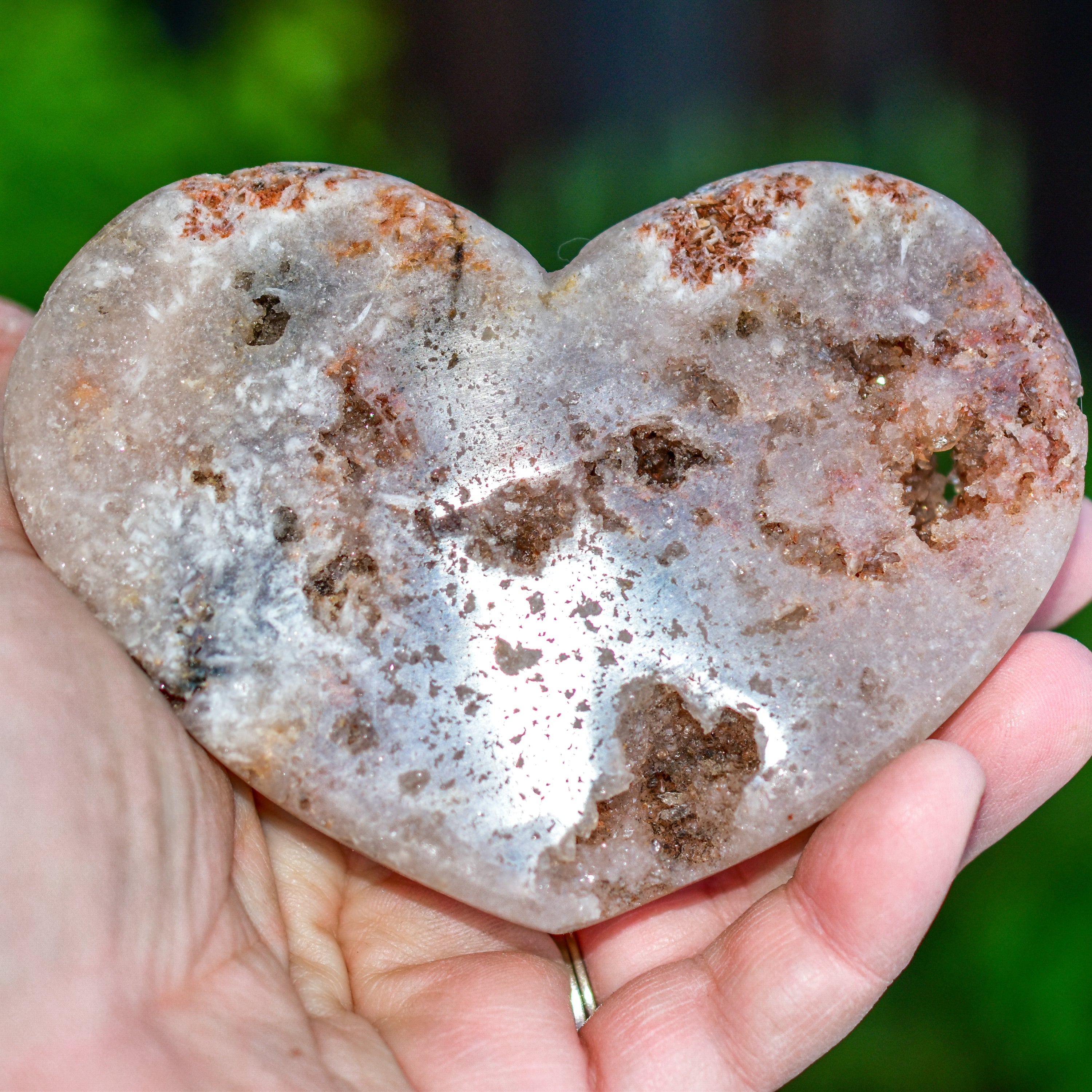 A collection of hand-cut Pink Amethyst hearts showcasing unique colors and sizes, polished to perfection by artisans in Brazil.