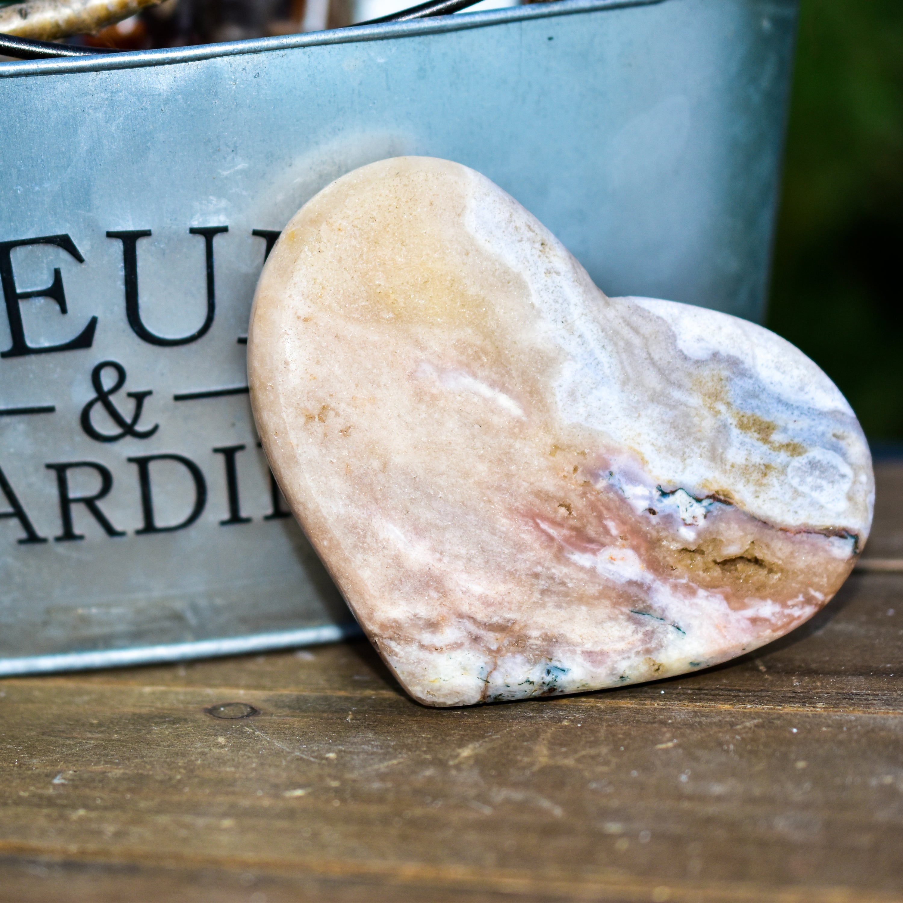 A collection of hand-cut Pink Amethyst hearts showcasing unique colors and sizes, polished to perfection by artisans in Brazil.