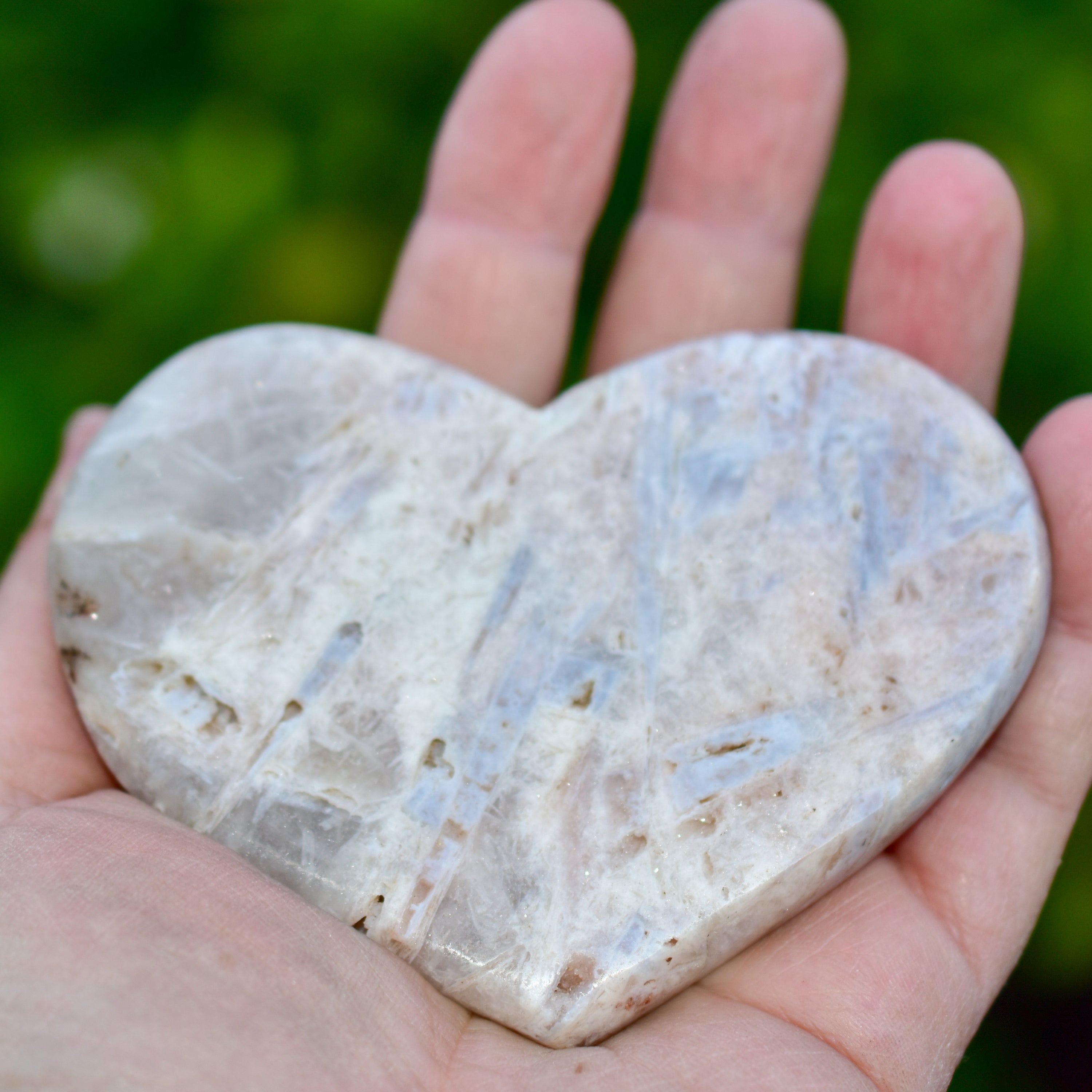 A collection of hand-cut Pink Amethyst hearts showcasing unique colors and sizes, polished to perfection by artisans in Brazil.