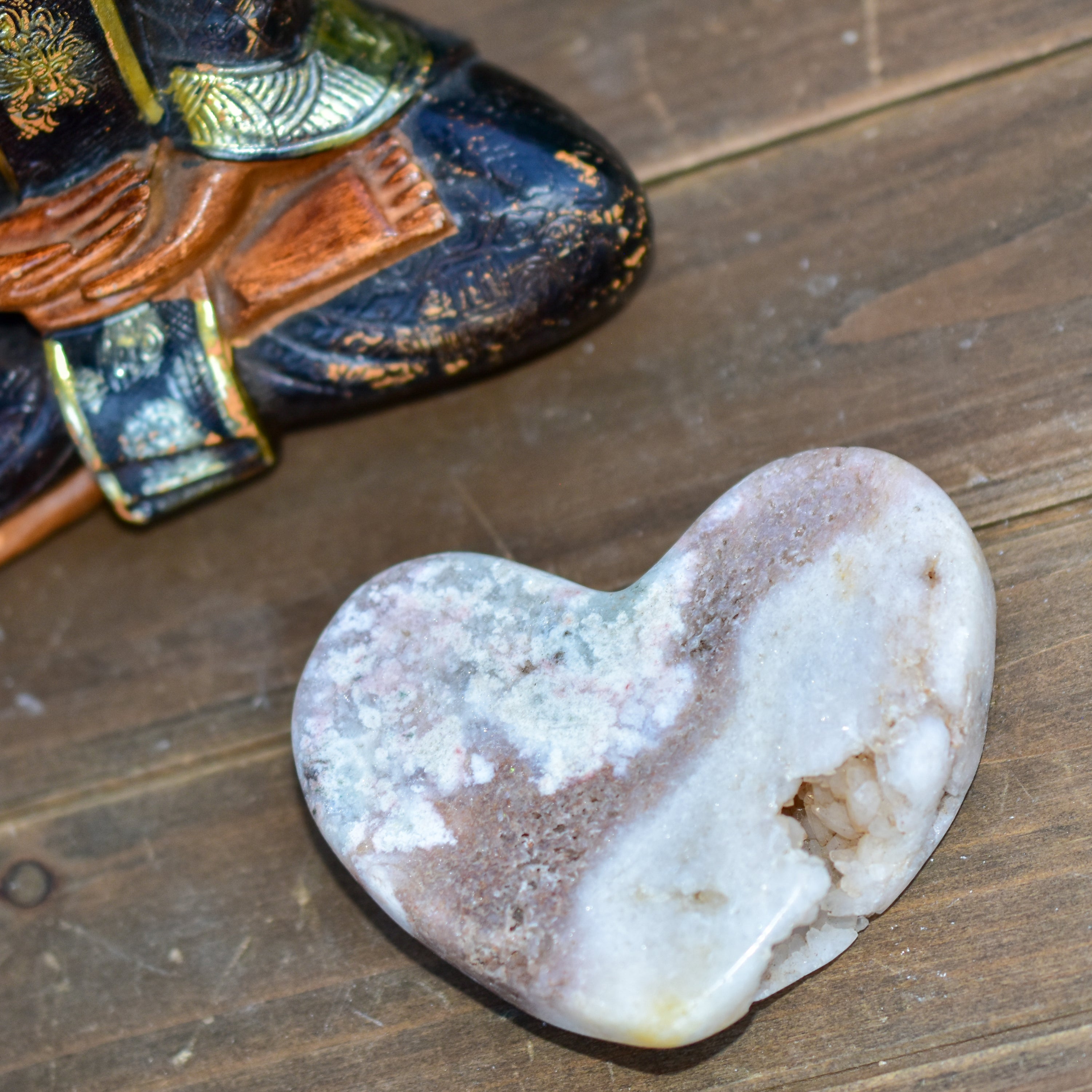 A collection of hand-cut Pink Amethyst hearts showcasing unique colors and sizes, polished to perfection by artisans in Brazil.