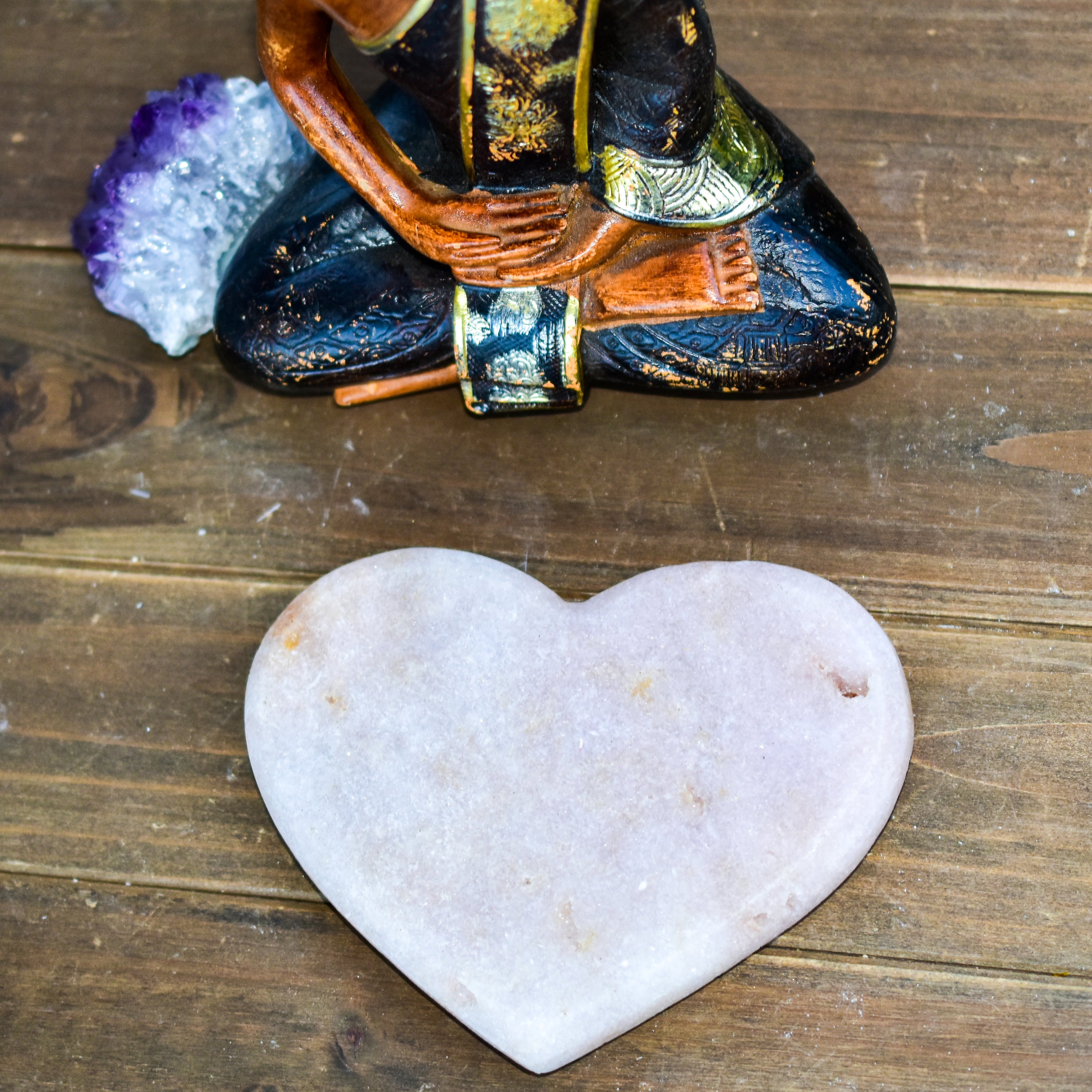 A collection of hand-cut Pink Amethyst hearts showcasing unique colors and sizes, polished to perfection by artisans in Brazil.