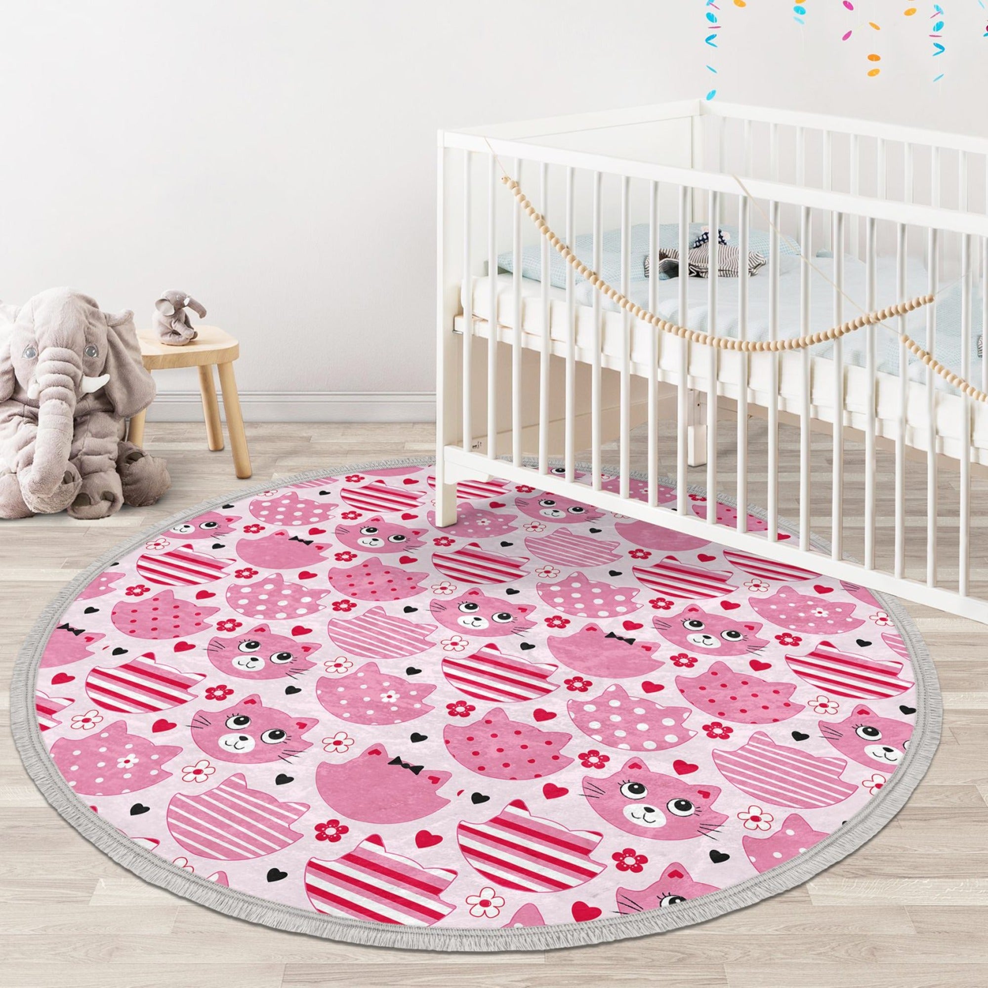 A round pink cat nursery rug featuring a cute cat design, made of shiny velvet fabric, perfect for kids' rooms.