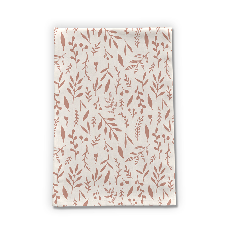 A pink tea towel featuring falling leaves design, made of cotton twill, perfect for kitchen use.