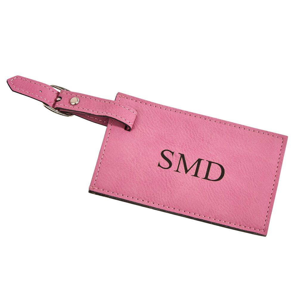 A vibrant pink leatherette luggage tag with a clear window for personal information and a buckled strap.