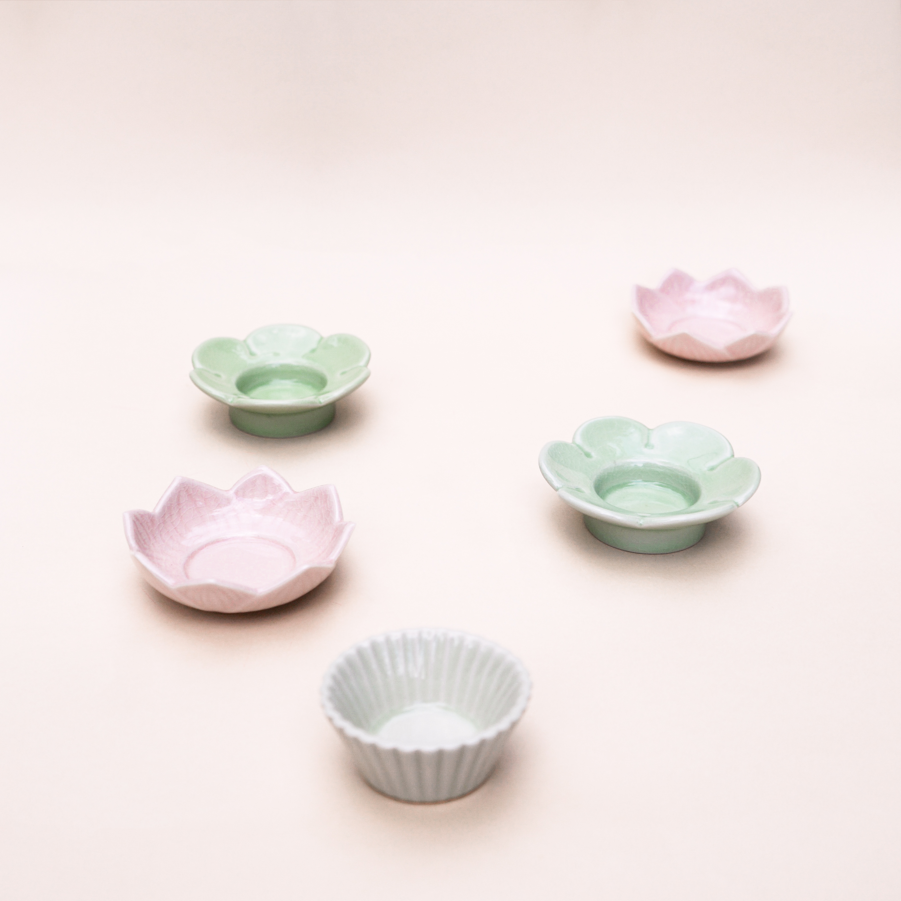 Handmade Pink Lotus Stoneware Tealight Holder featuring a delicate lotus design, perfect for standard tealight candles.