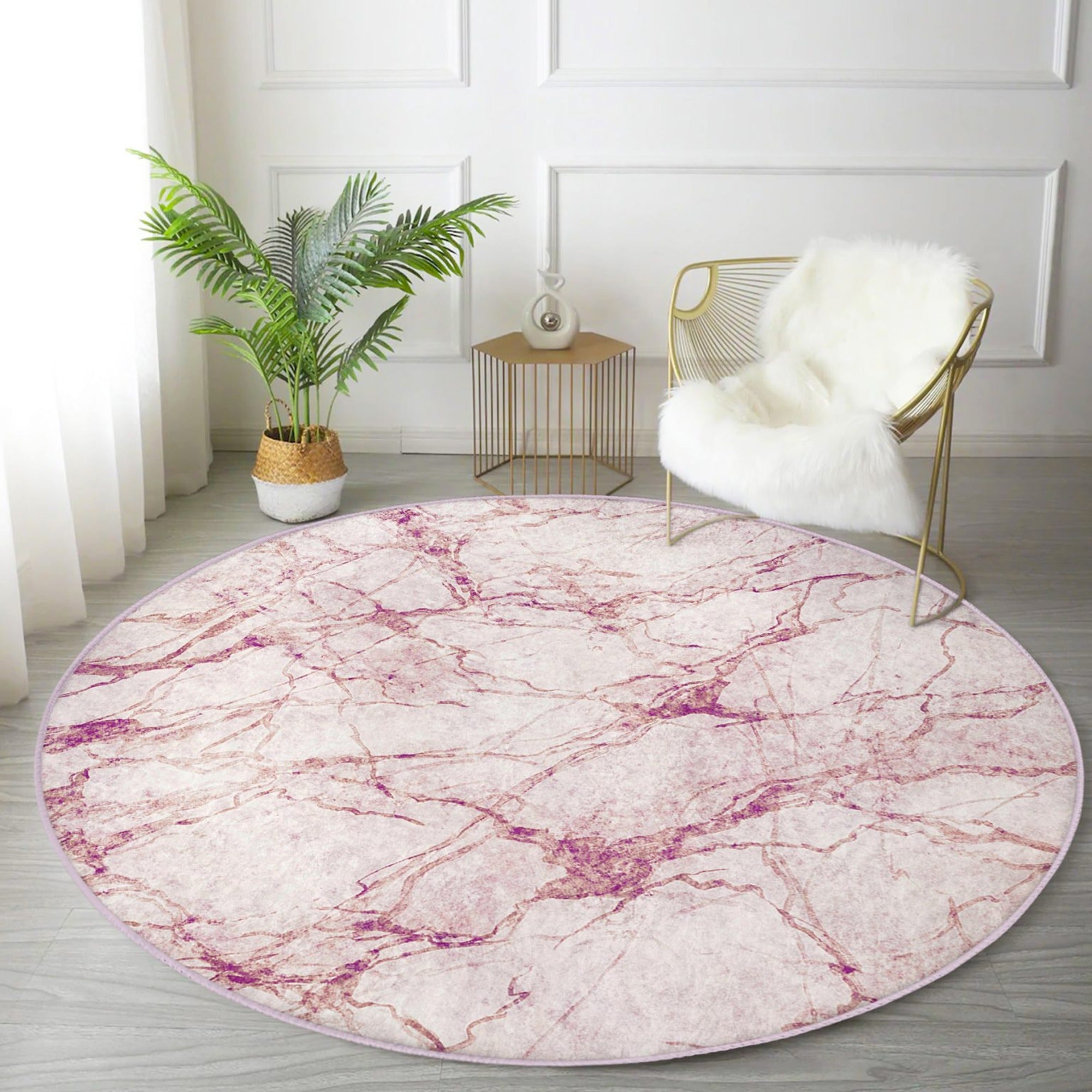 A stylish pink marble pattern round rug, perfect for home decor, showcasing a soft velvet texture and vibrant colors.