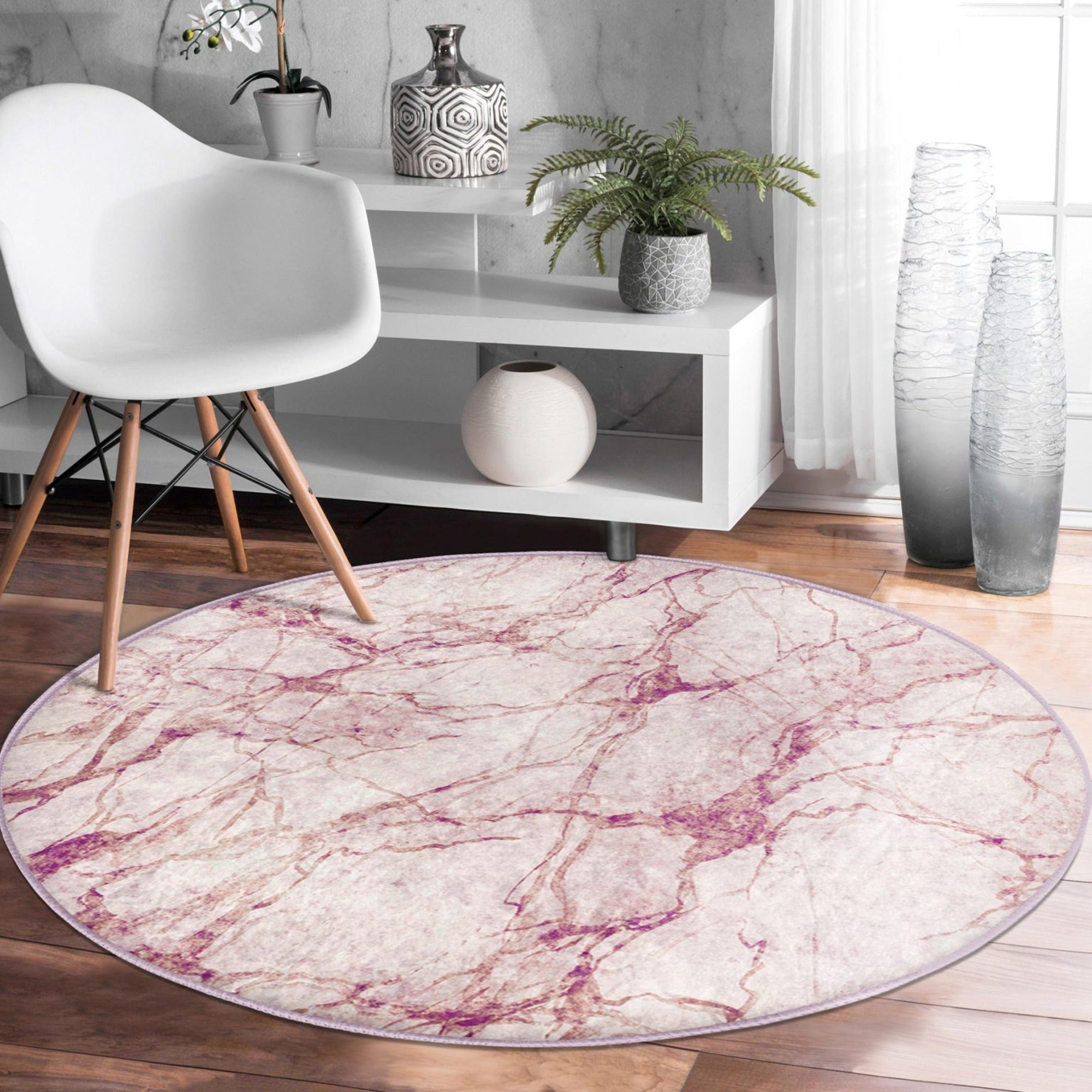 A stylish pink marble pattern round rug, perfect for home decor, showcasing a soft velvet texture and vibrant colors.