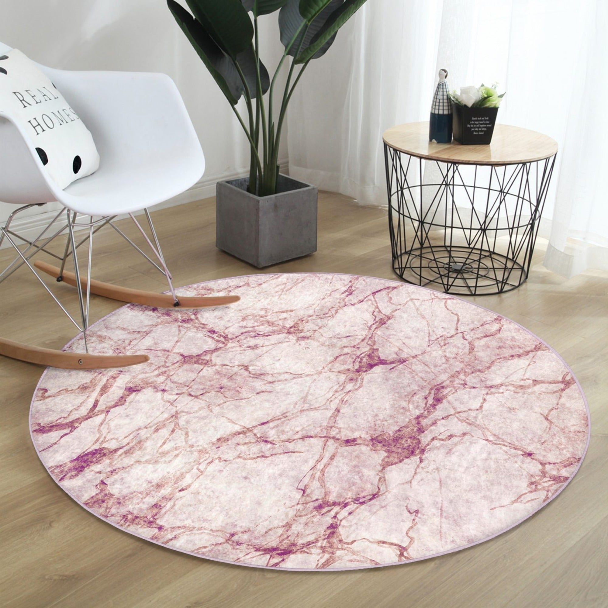 A stylish pink marble pattern round rug, perfect for home decor, showcasing a soft velvet texture and vibrant colors.