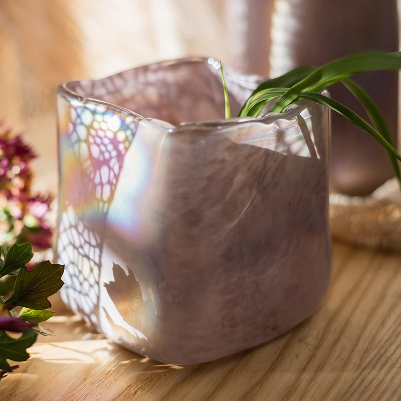 A beautiful hand-blown glass vase in pink Morandi color, showcasing unique shapes and colors, perfect for floral arrangements.