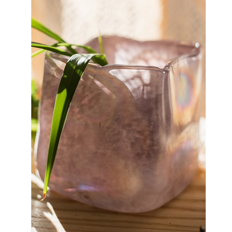 A beautiful hand-blown glass vase in pink Morandi color, showcasing unique shapes and colors, perfect for floral arrangements.