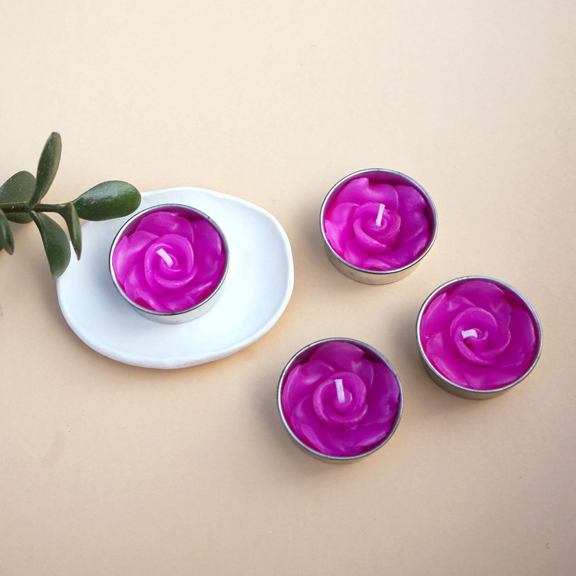 A set of eight pink rose scented tealights in a decorative botanic garden printed box, showcasing their elegant design and inviting fragrance.