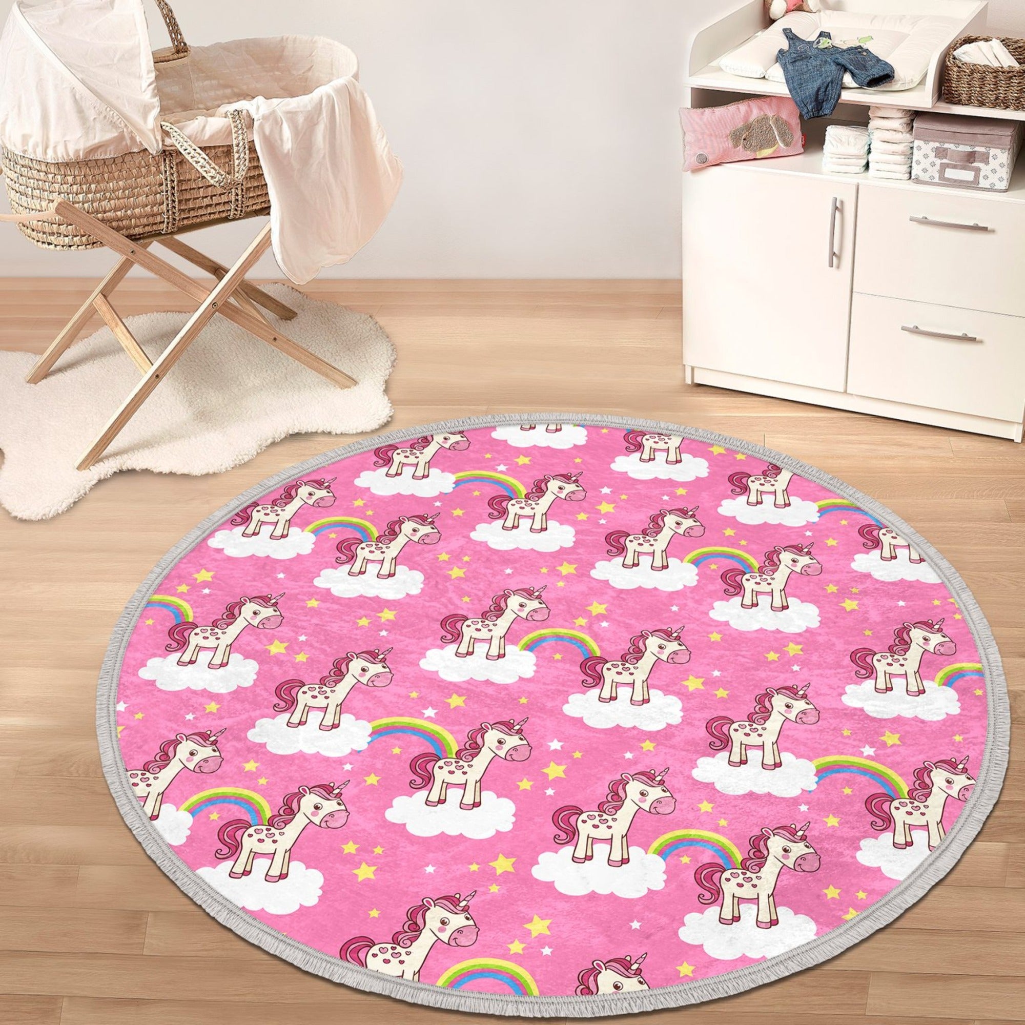 A vibrant pink round rug featuring a whimsical unicorn design, perfect for kids' rooms, made of soft velvet fabric with fringes.