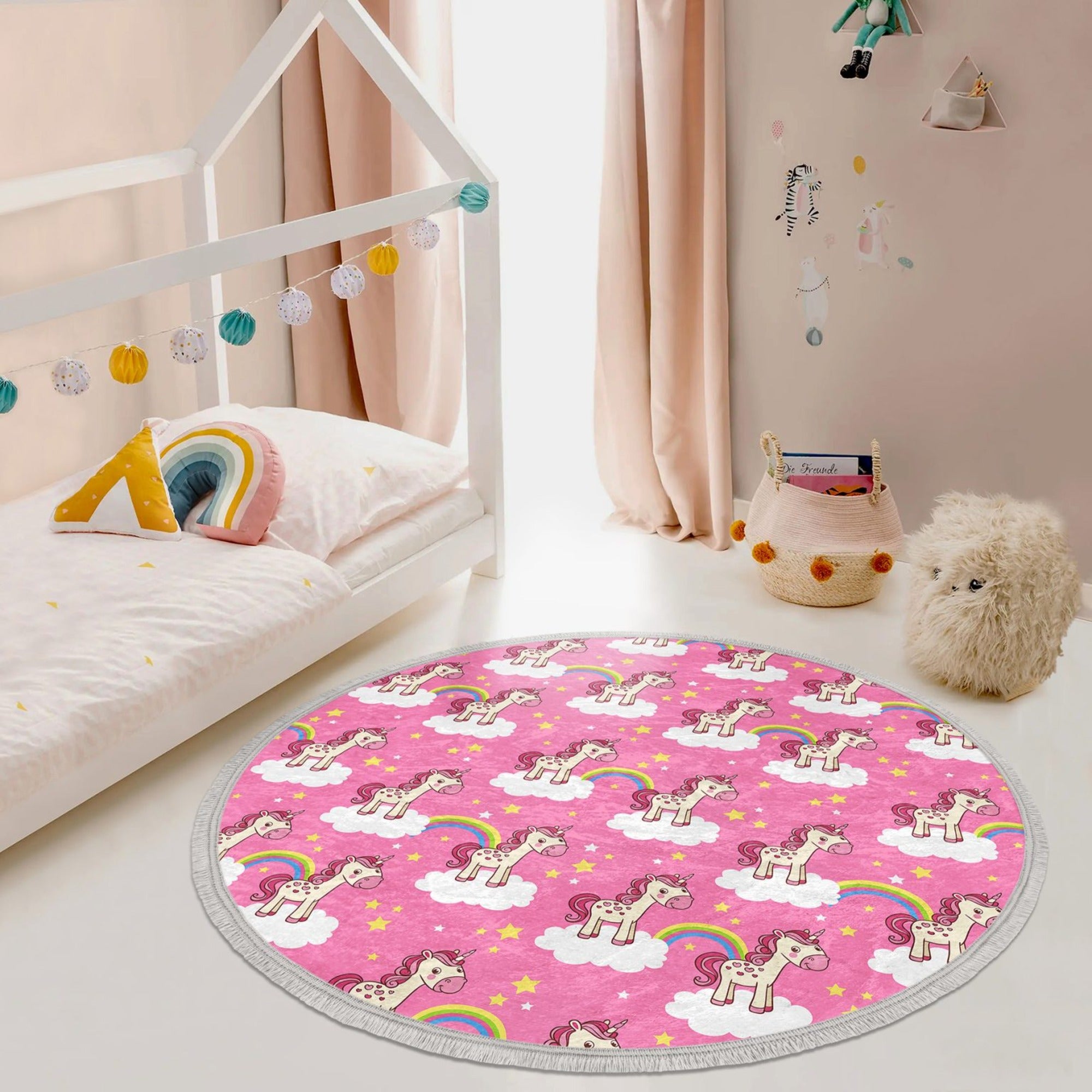 A vibrant pink round rug featuring a whimsical unicorn design, perfect for kids' rooms, made of soft velvet fabric with fringes.