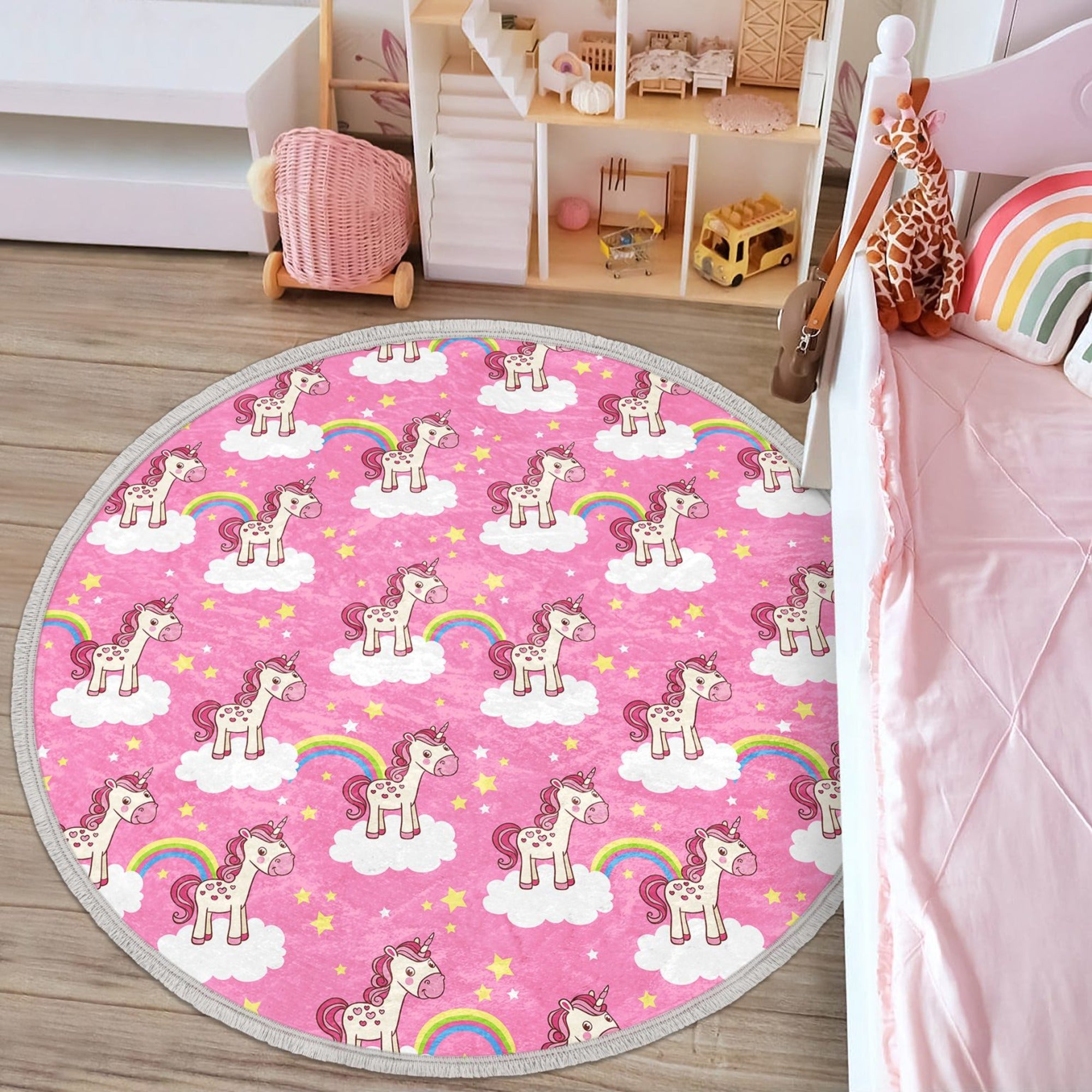 A vibrant pink round rug featuring a whimsical unicorn design, perfect for kids' rooms, made of soft velvet fabric with fringes.