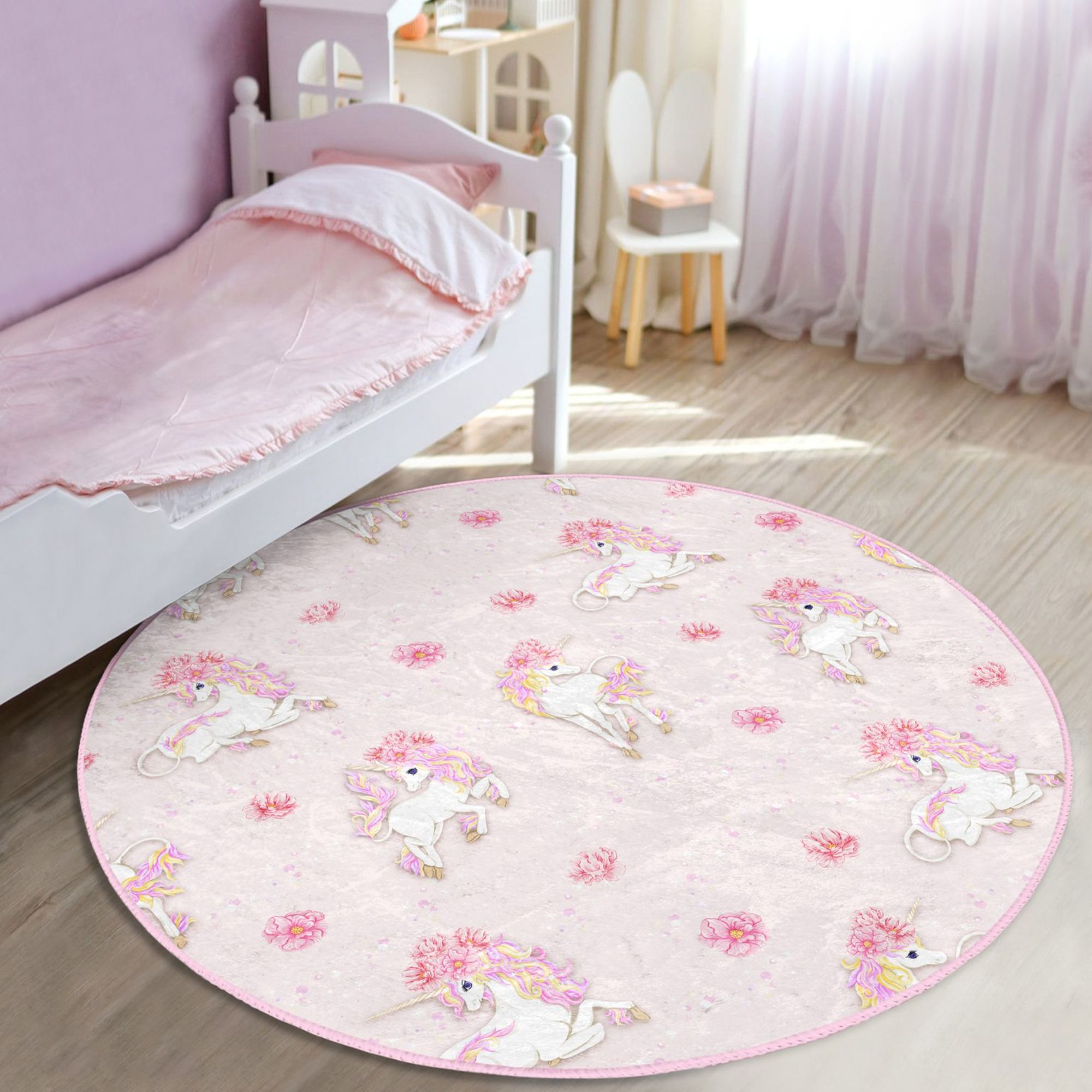 A vibrant pink rug featuring a whimsical unicorn pattern, perfect for a girl's room or nursery, made from soft and durable materials.