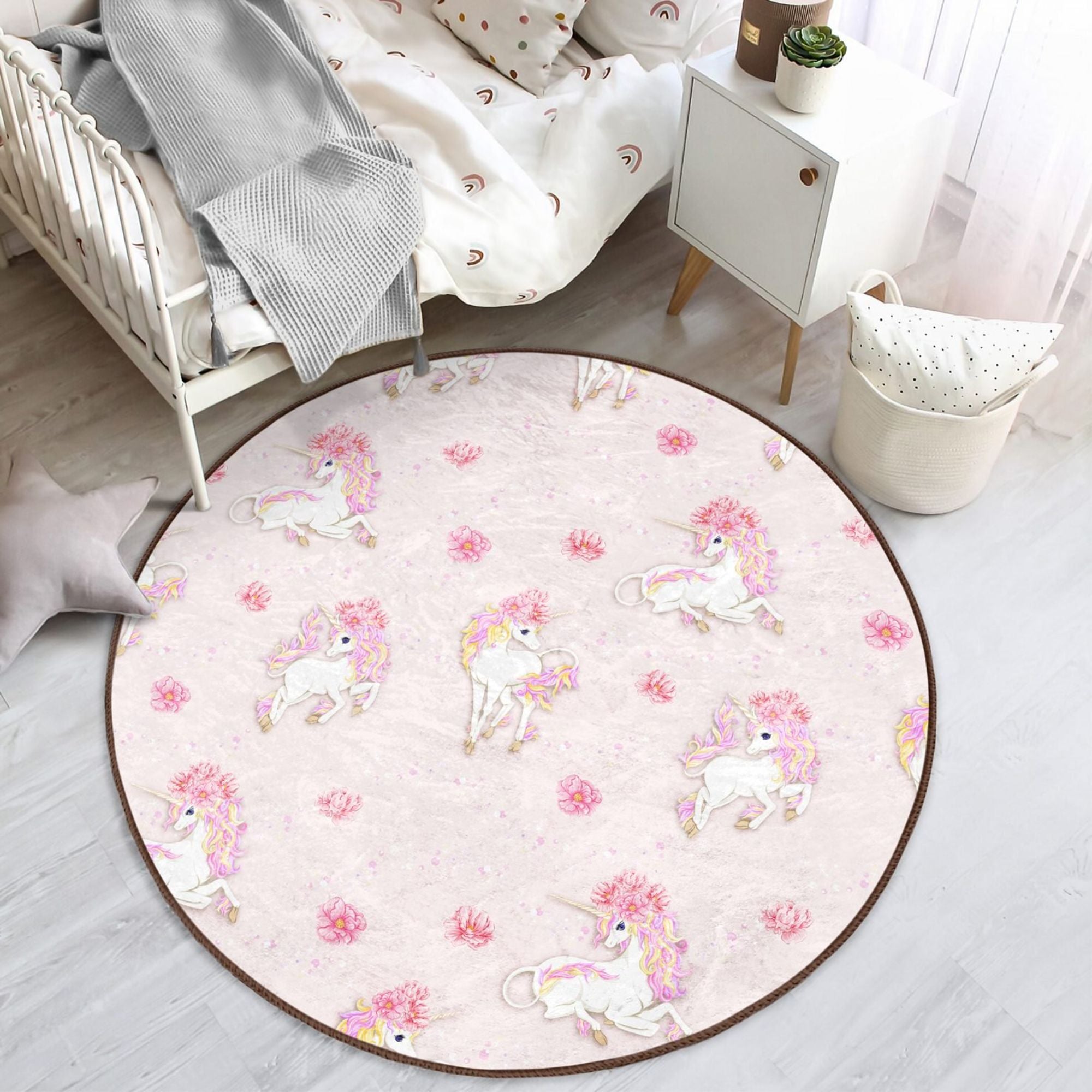 A vibrant pink rug featuring a whimsical unicorn pattern, perfect for a girl's room or nursery, made from soft and durable materials.