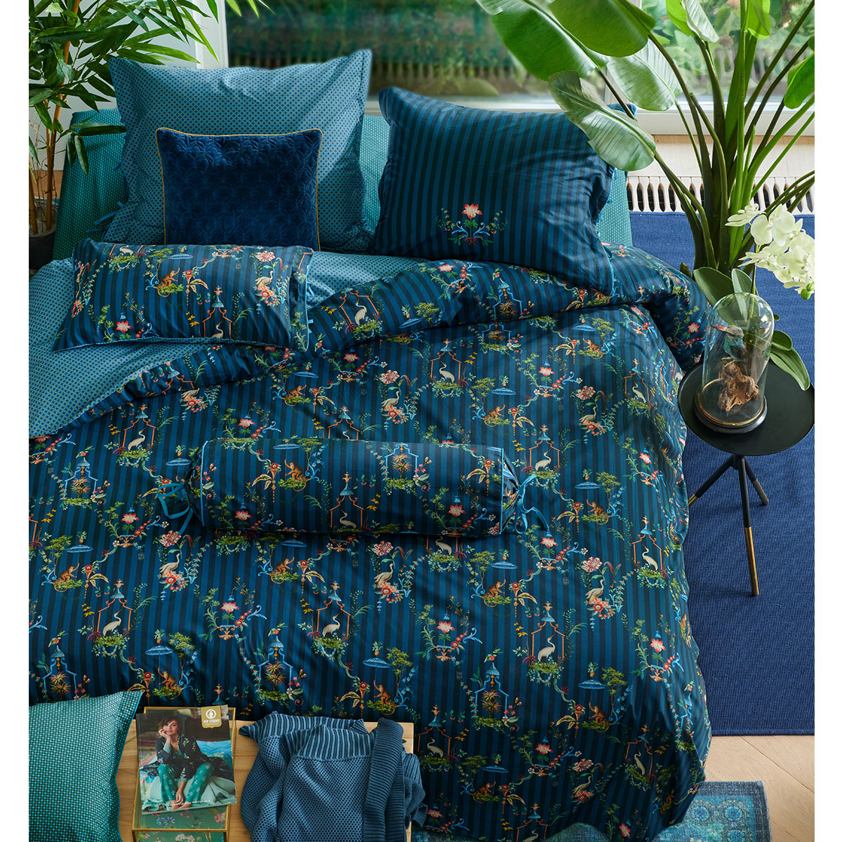 PIP Studio Singerie Dark Blue Cotton Quilt Cover Set featuring vibrant scenes of birds and monkeys, with a luxurious cotton finish.